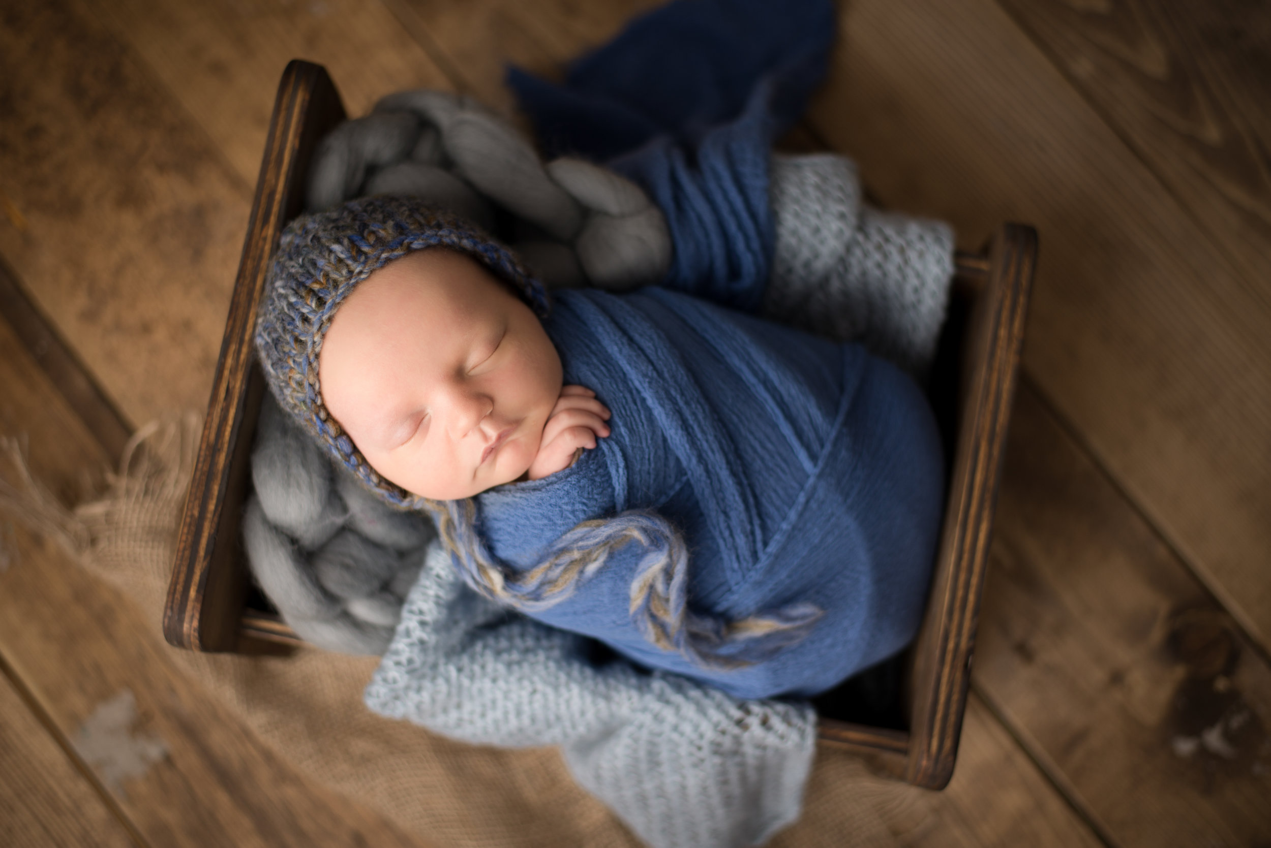calgary newborn baby photography boy blue wood prop photo