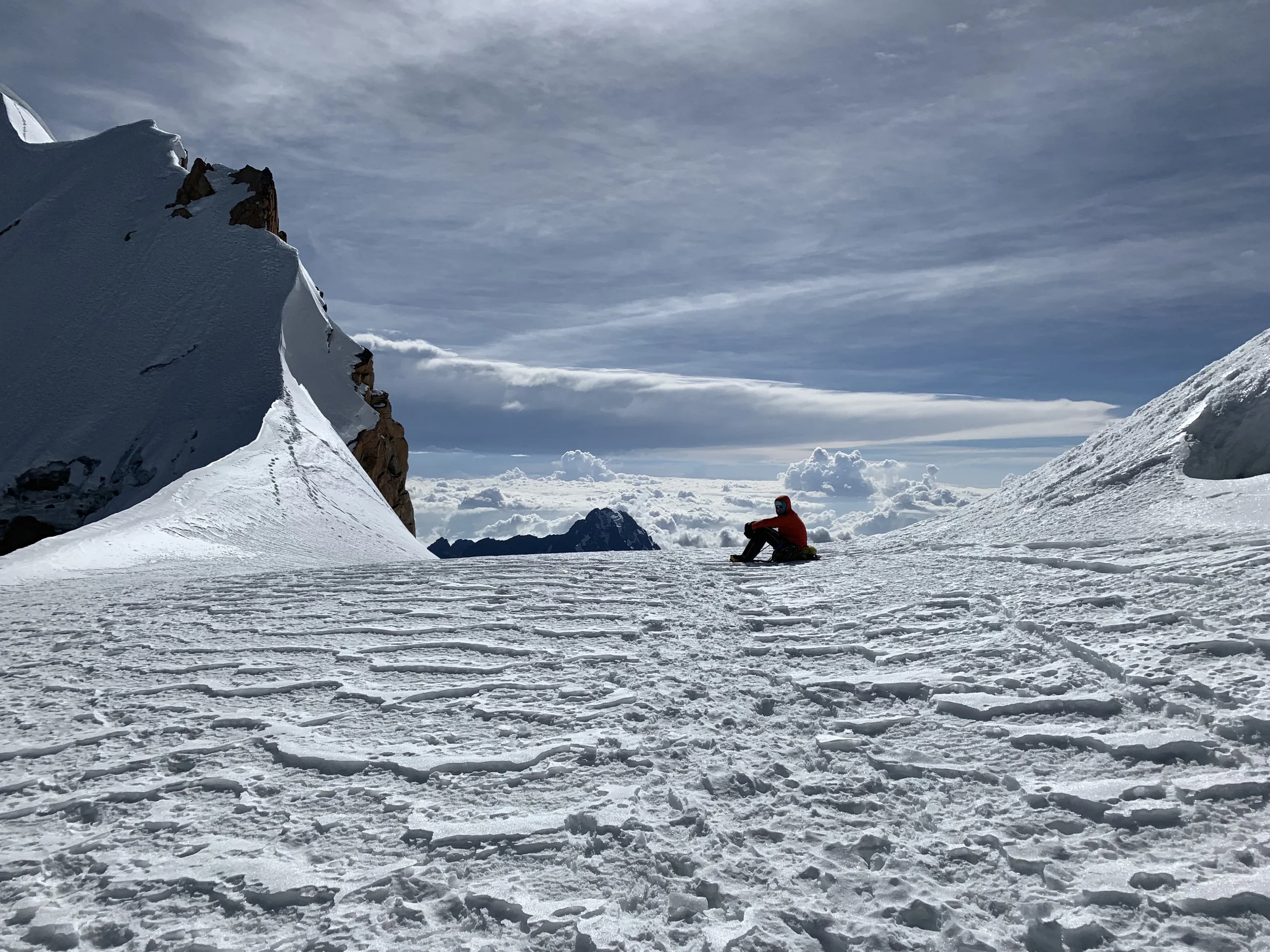 Taking a break in the saddle before the summit ridge. Photo by Dale Apgar.