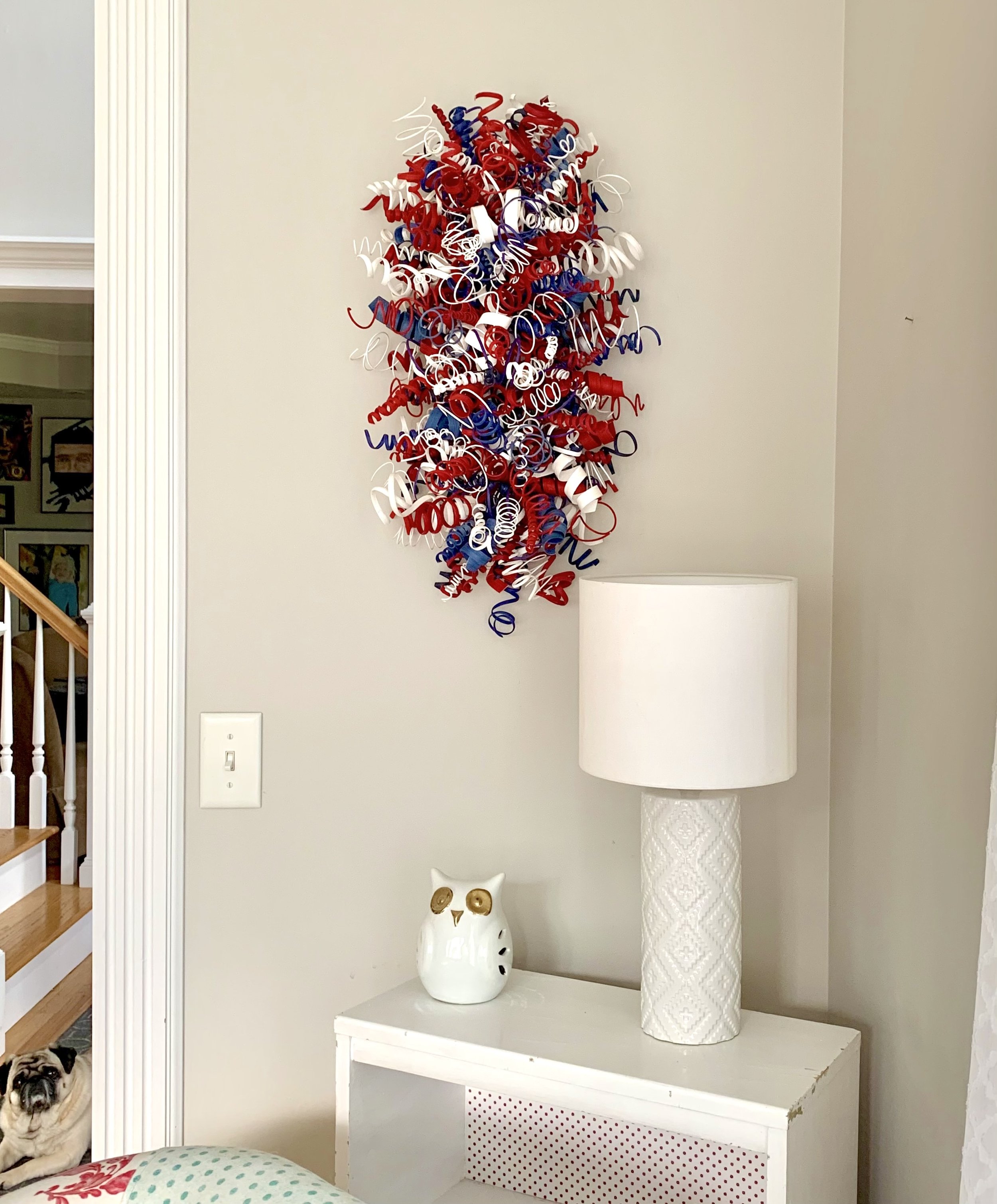 Abstract modern wood sculpture with bold red, blue, and white colors