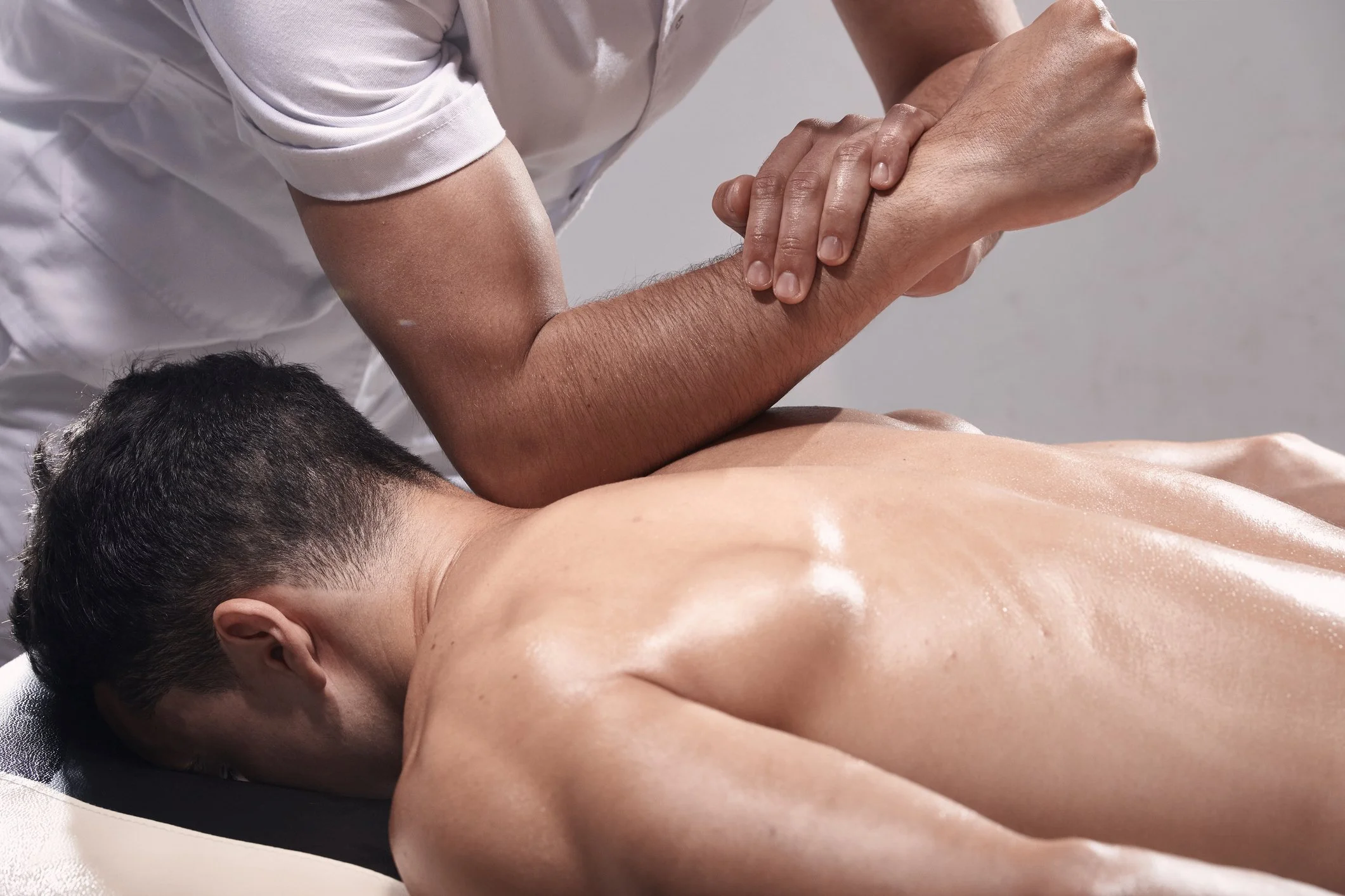 Therapist performing deep tissue medical massage on a patient's back at Blue Sky Acupuncture in Woodbury NY