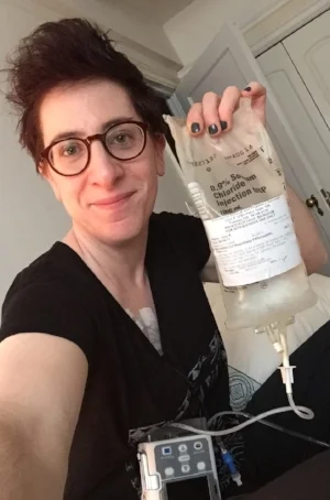 This is my little home-IV fluids kit. The electronic pump at the bottom of the photo regulates how fast the saline is pumped into me (the rate is 500 which is 1 liter per hour). The saline must be refrigerated which is why I usually have a blanket over me because I get cold from it going into my veins! And the port needle in my chest needs to stay "accessed" all week - which means inside of me - so that I can give the fluids to myself. It's itchy and annoying but man, I'm rethinking how I'll handle it moving forward since I feel better getting the liter per day.... 