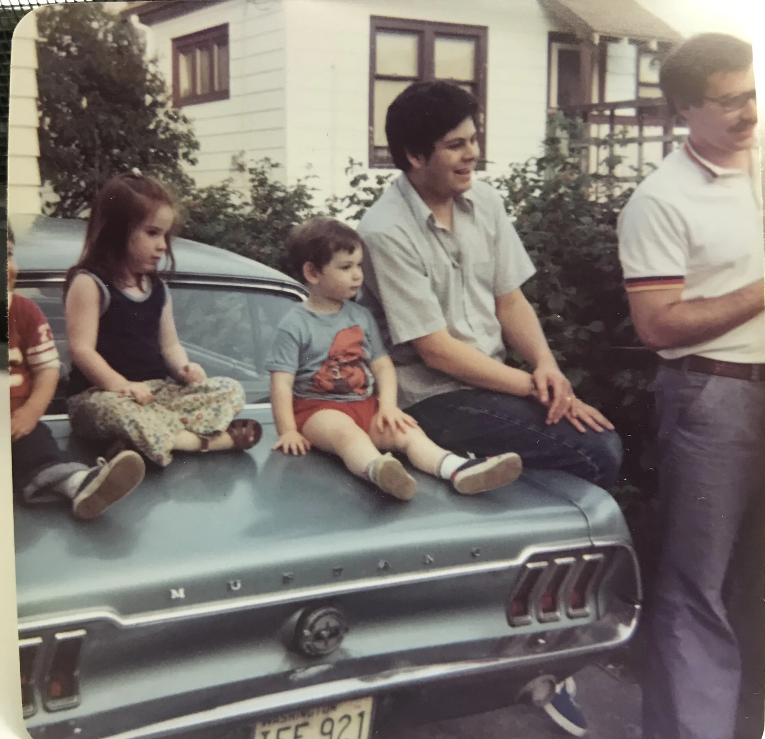 This must be summer of 1975 so I’m 4, almost 5 years old - that’s me with the red hair on our blue mustang we had when I was small. We’d slide around the back seat - omg the safety back then was so bad - you can see how short my arms next to my cousin who must be barely 2 years old. My brother is to my right, then two uncles on the end. I think it was 4th of July, I don’t know why I remember that but look how serious I am while everyone else is smiling. I was a very, very serious kid.