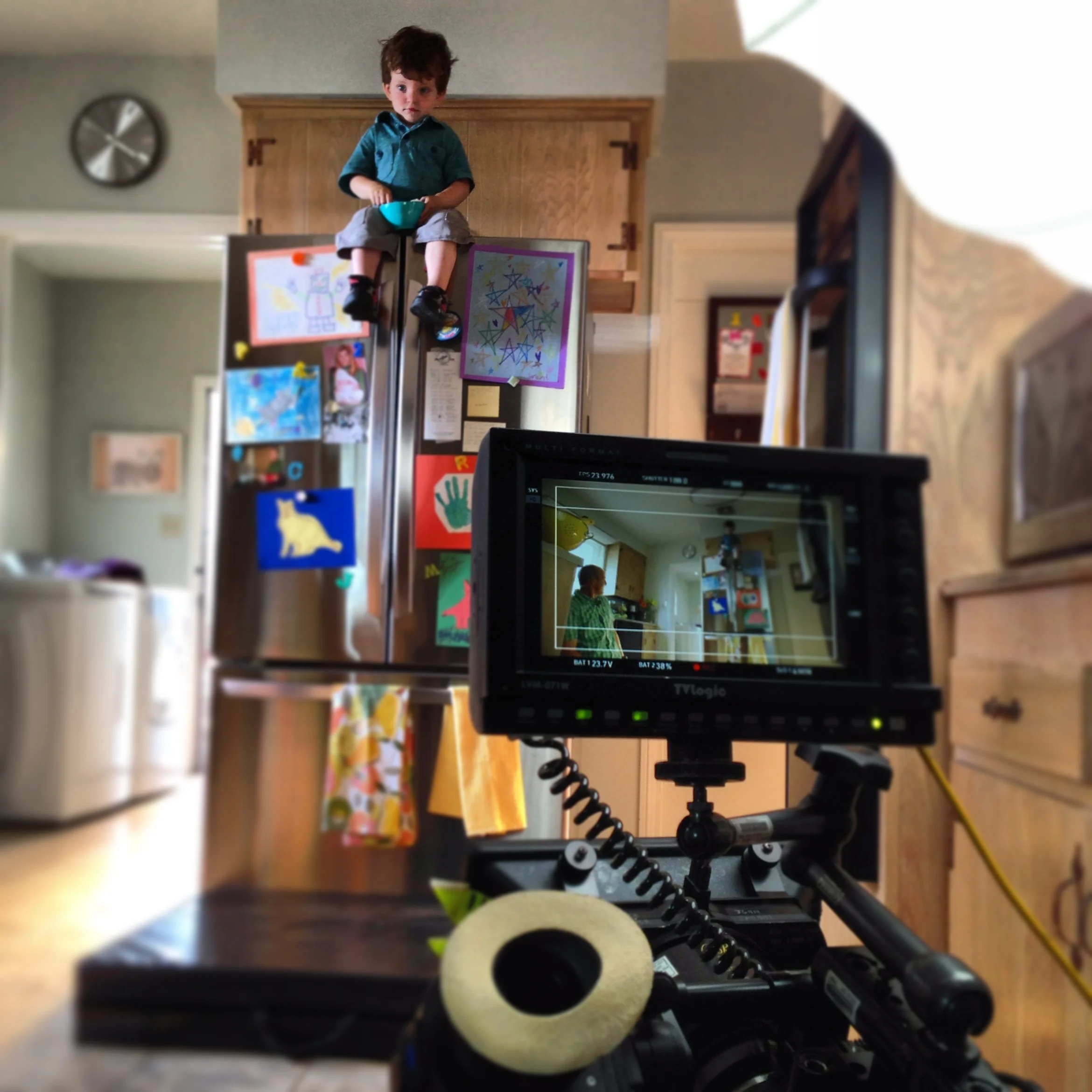  Putting a child on top of a refrigerator! The kid was harnessed in with a safety belt hidden behind him, but I insisted on having people stationed just out of frame ready to catch him if anything went wrong with the belt. Safety is always the thing 