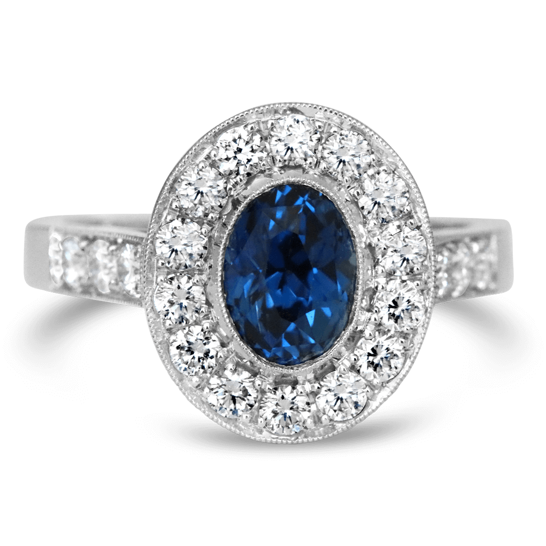 Platinum ring with Blue sapphire in center with diamond halo