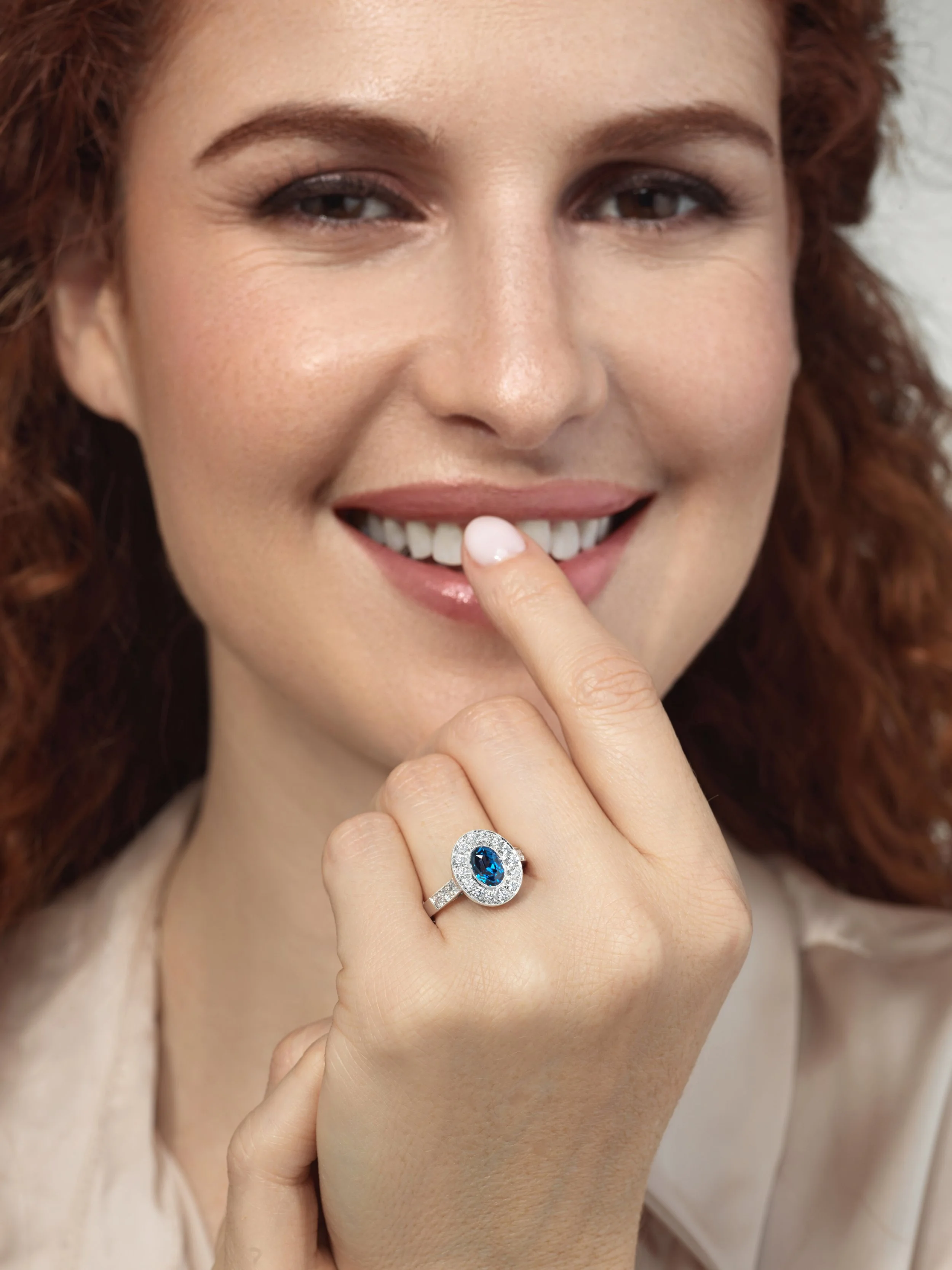 EJ model with blue sapphire ring on finger