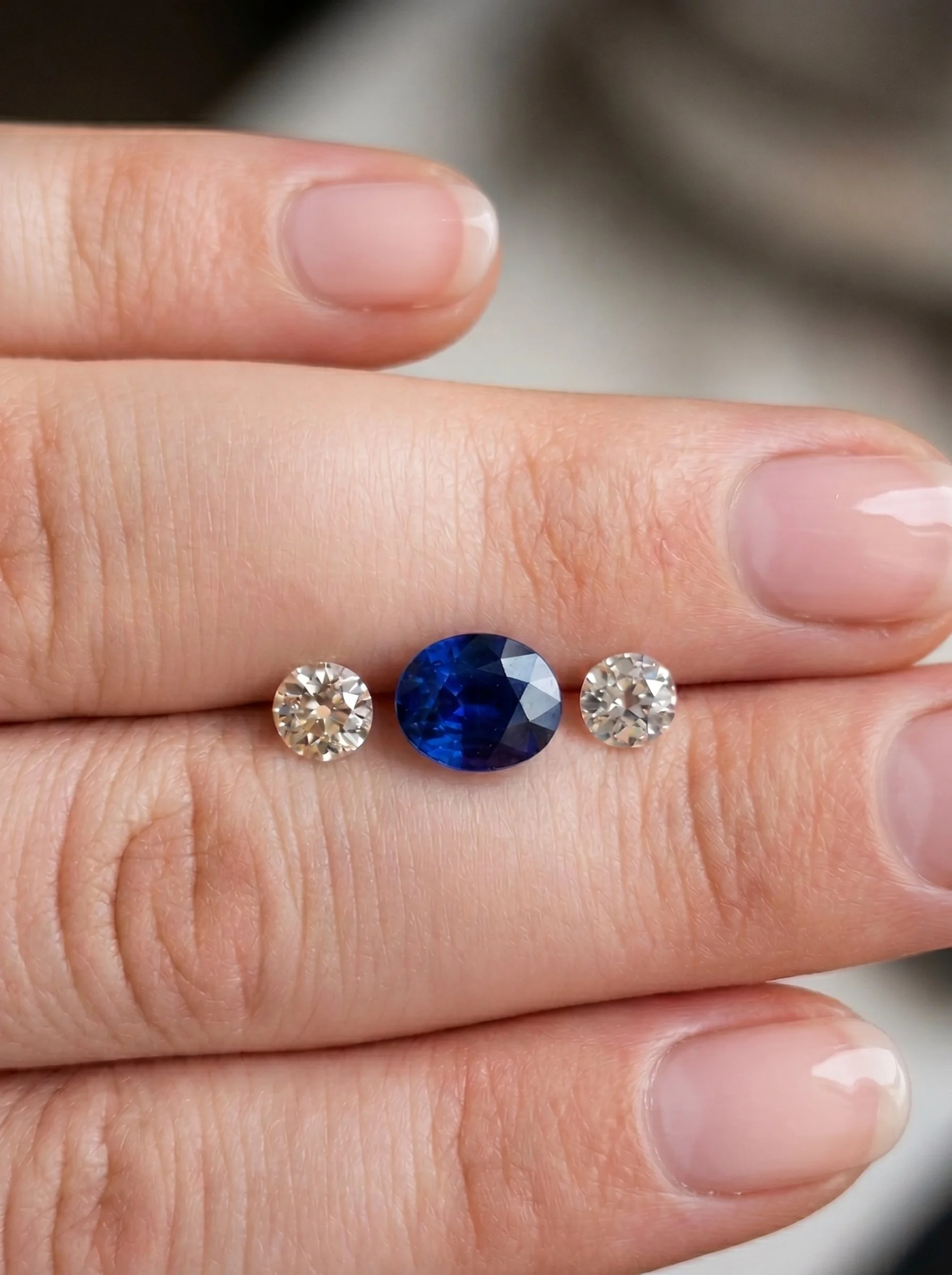 Blue sapphire two dimaonds gemstone on fingers