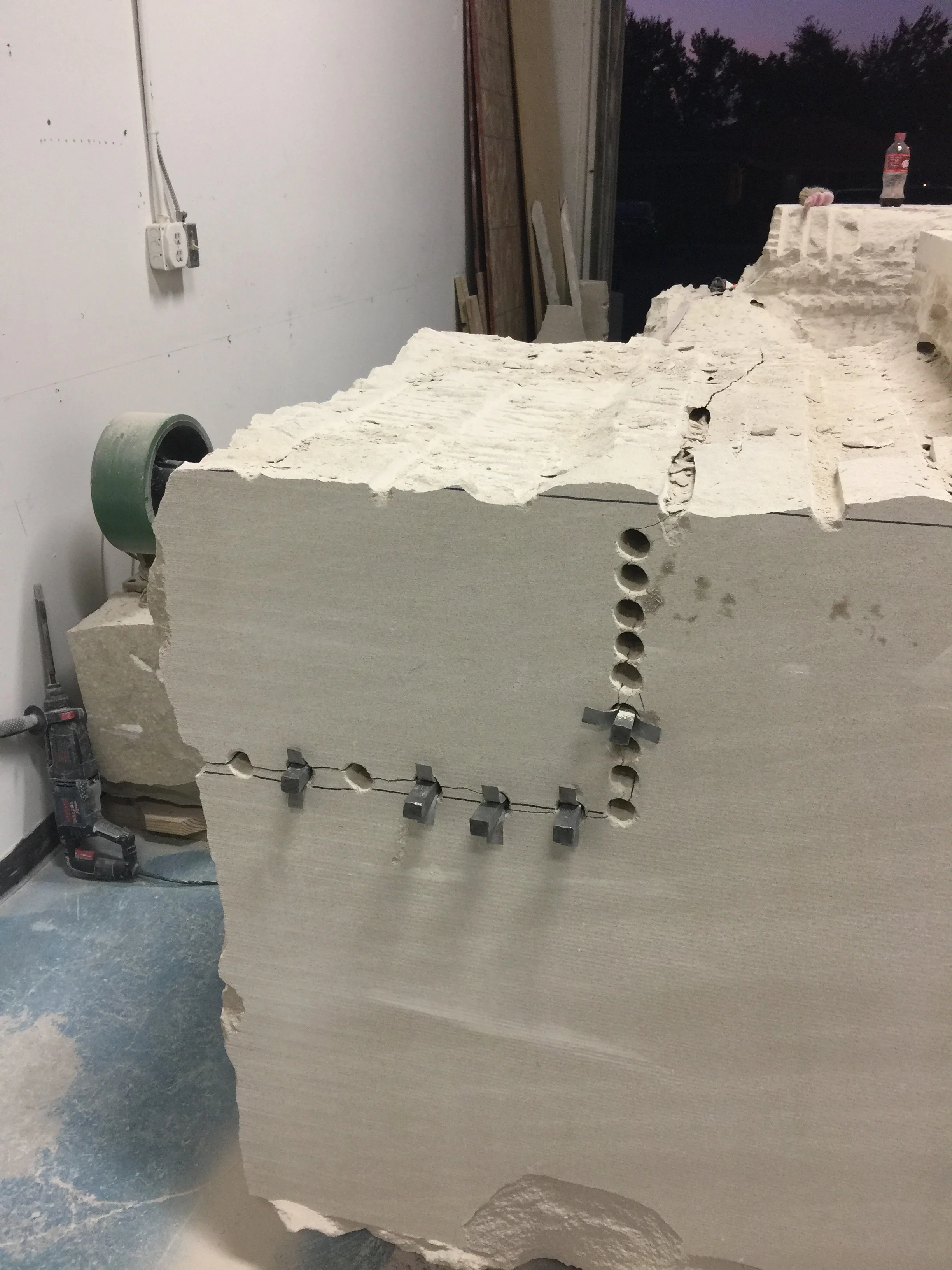 The feathers and wedges inserted in the drill holes.