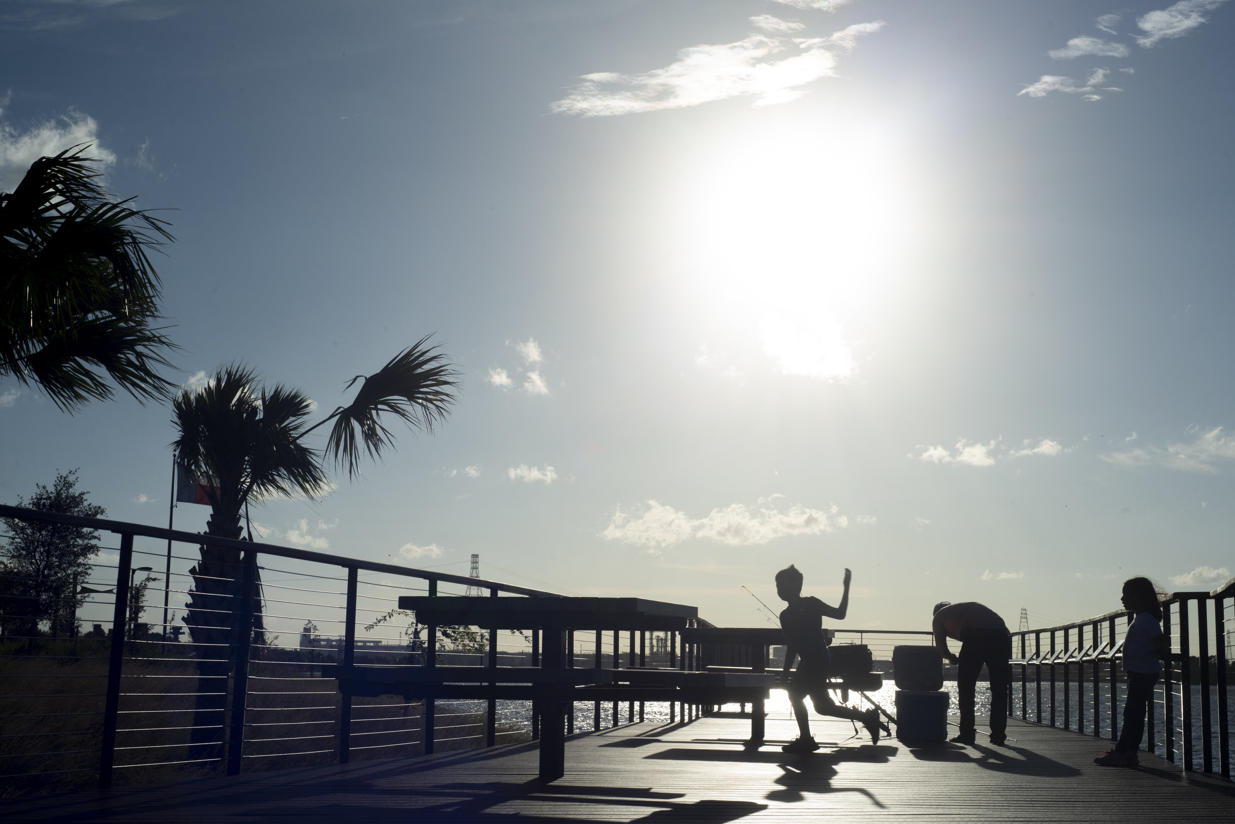  Sebastian runs while father, Rodrigo, sets up fishing poles in Houston, Texas Oct. 2018. It was a no fishing zone.  