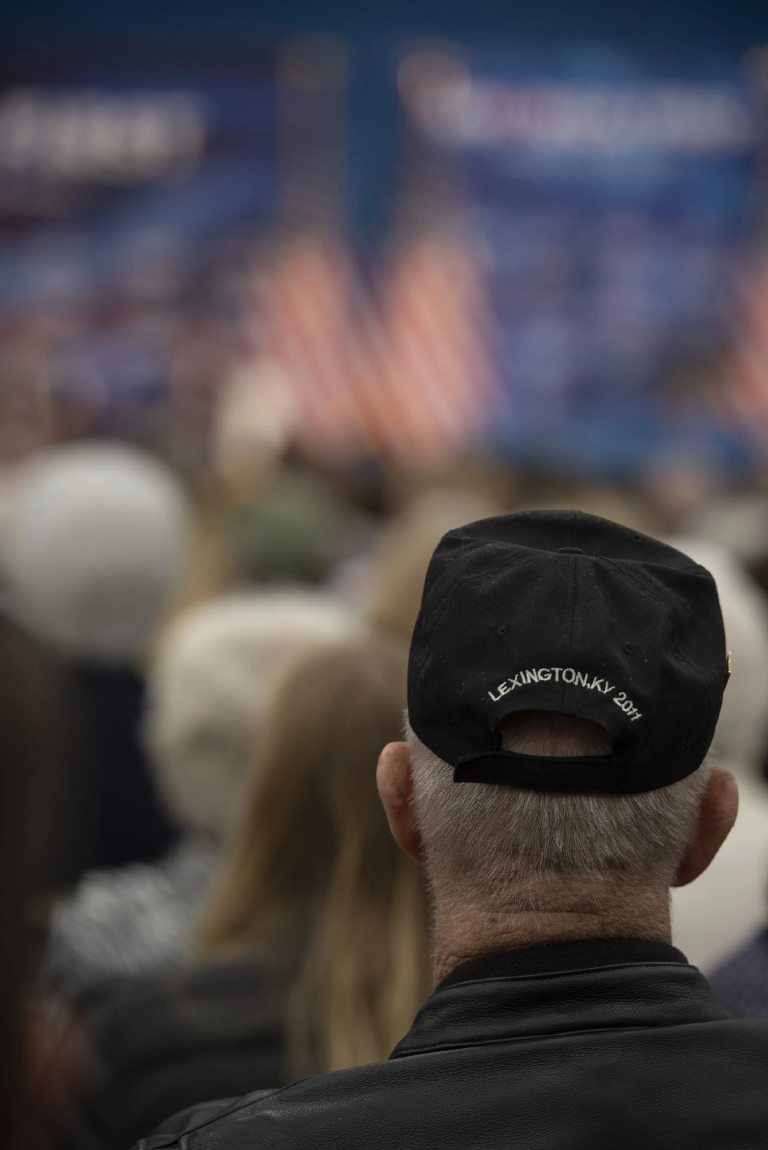  A man sits in the crowd of a few hundred people attending the Tax Cuts to Put America First rally in Versailles, Kentucky. Versailles was the fifth stop in the tour. 