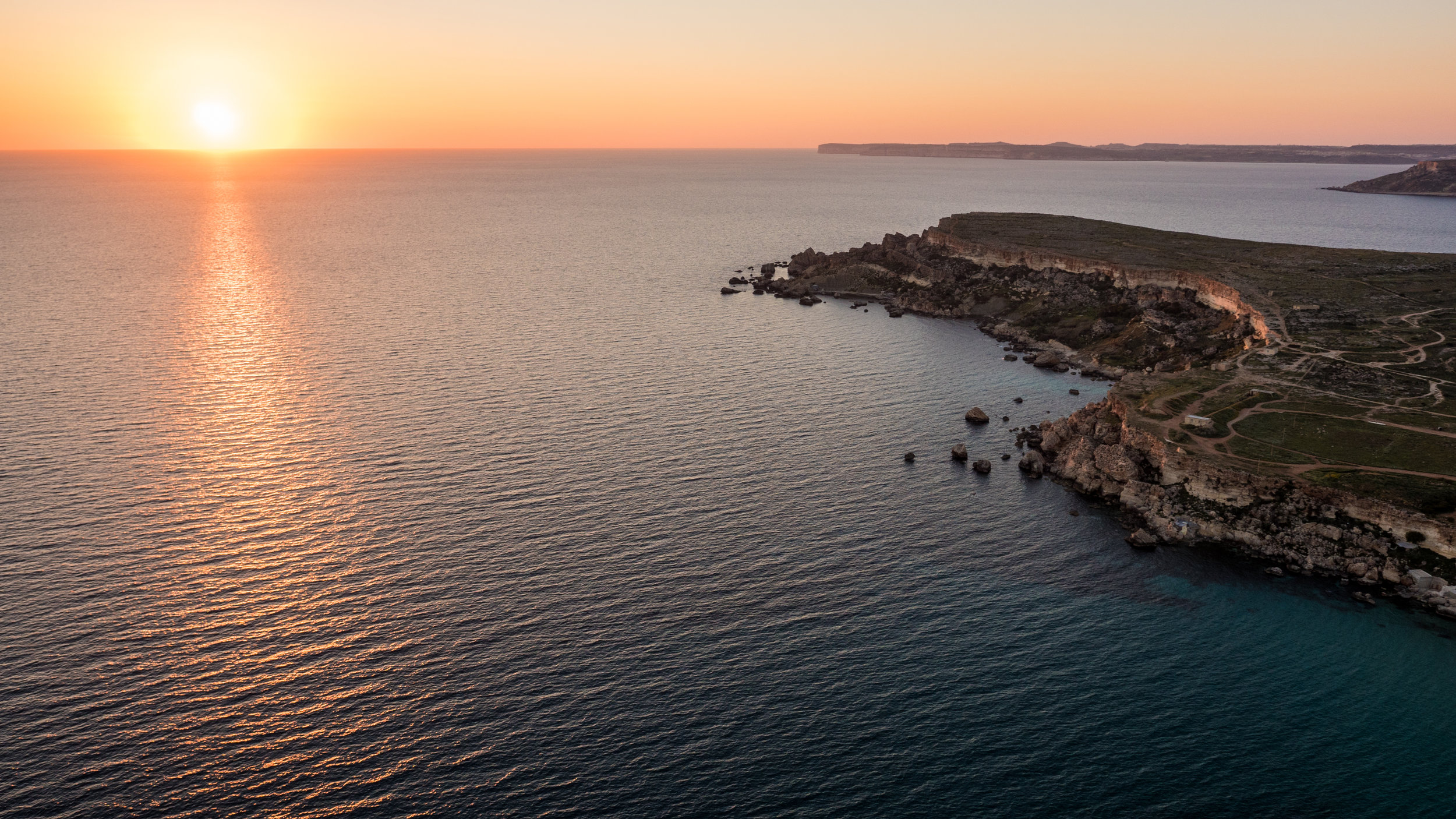 Aerial view of sunset on Golden Bay, Malta, one of my favourite sunset viewing points on the island
