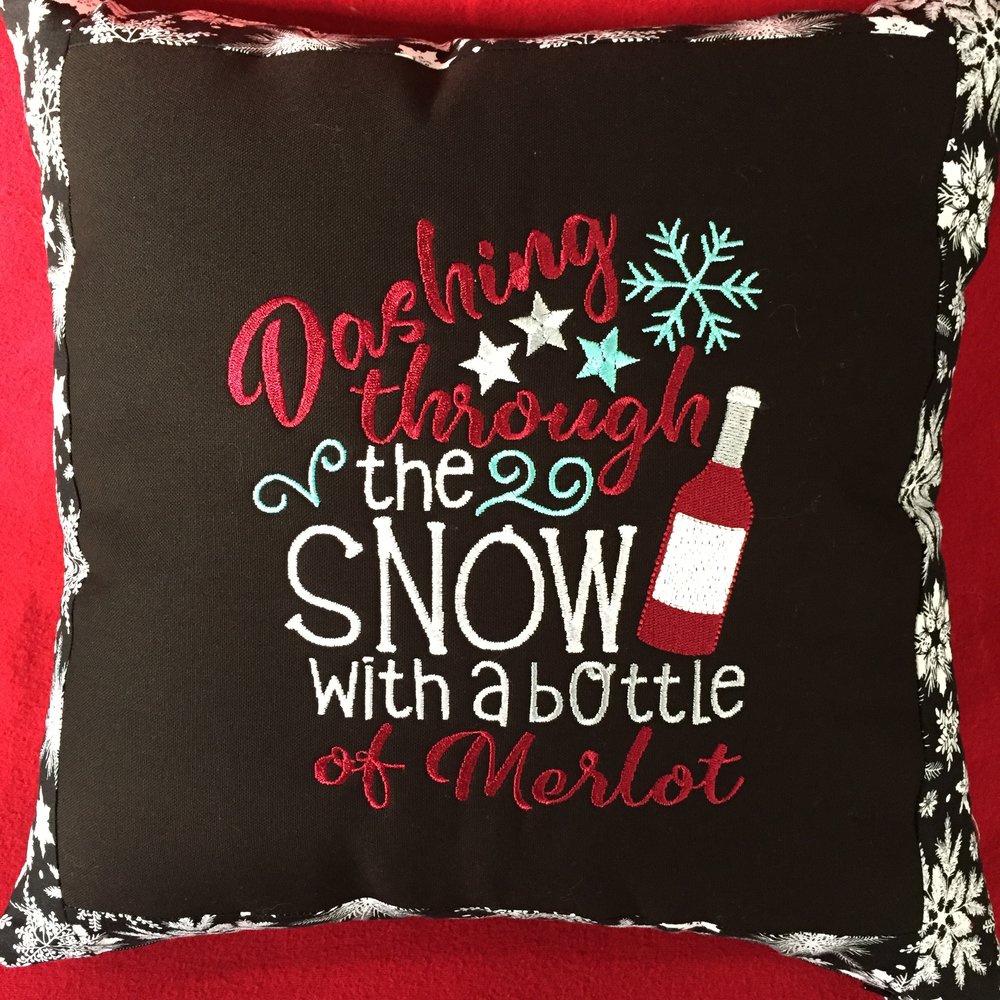 embroidered holiday throw pillow from Bobbins and Needles and Threads, Oh My! ($40 vaule)