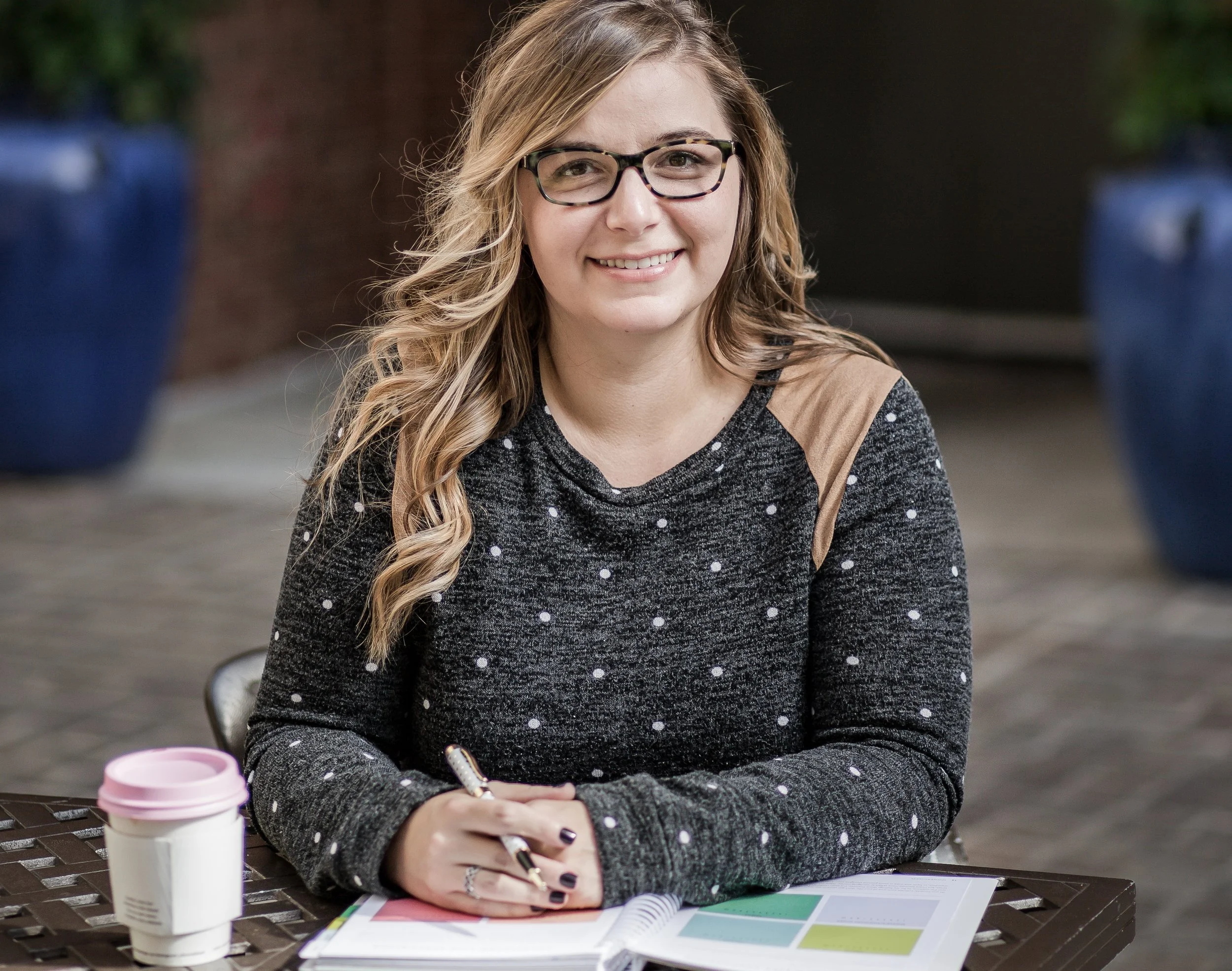 woman headshot smiling hands clasped