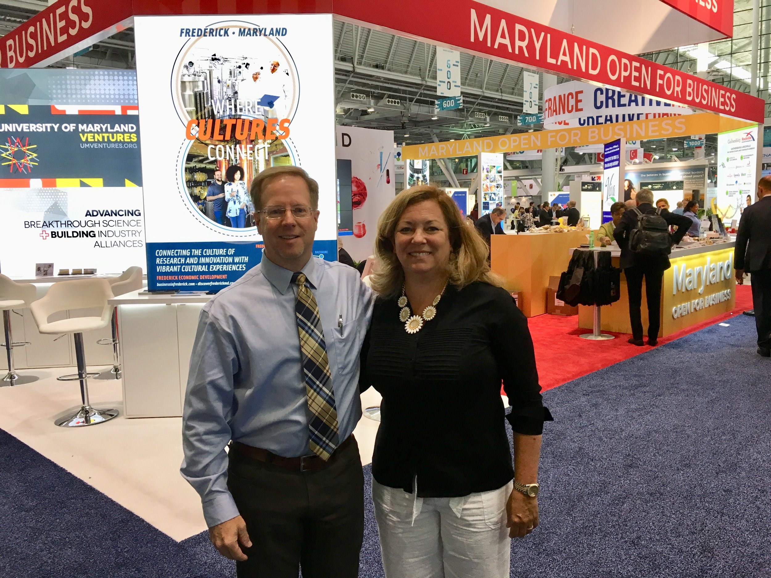 two people standing in front of conference
