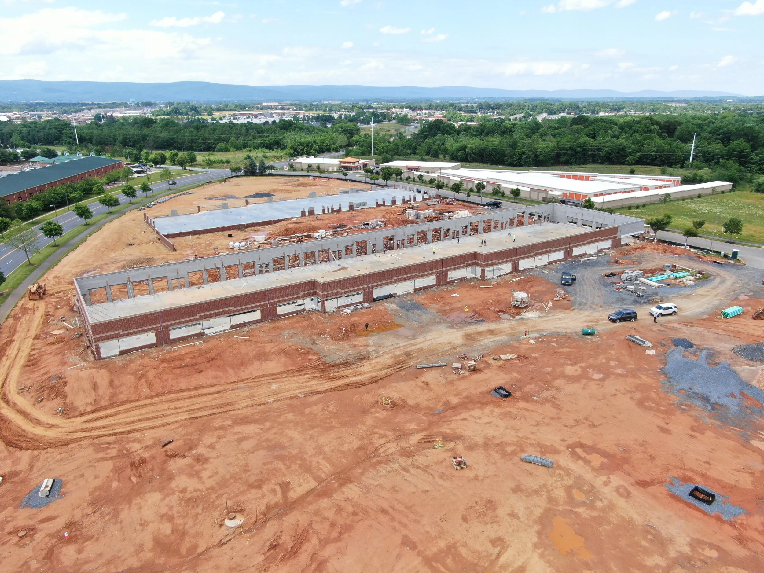 Overhead perspective of the Walmart distribution center construction site, featuring cranes and ongoing building activities..jpg