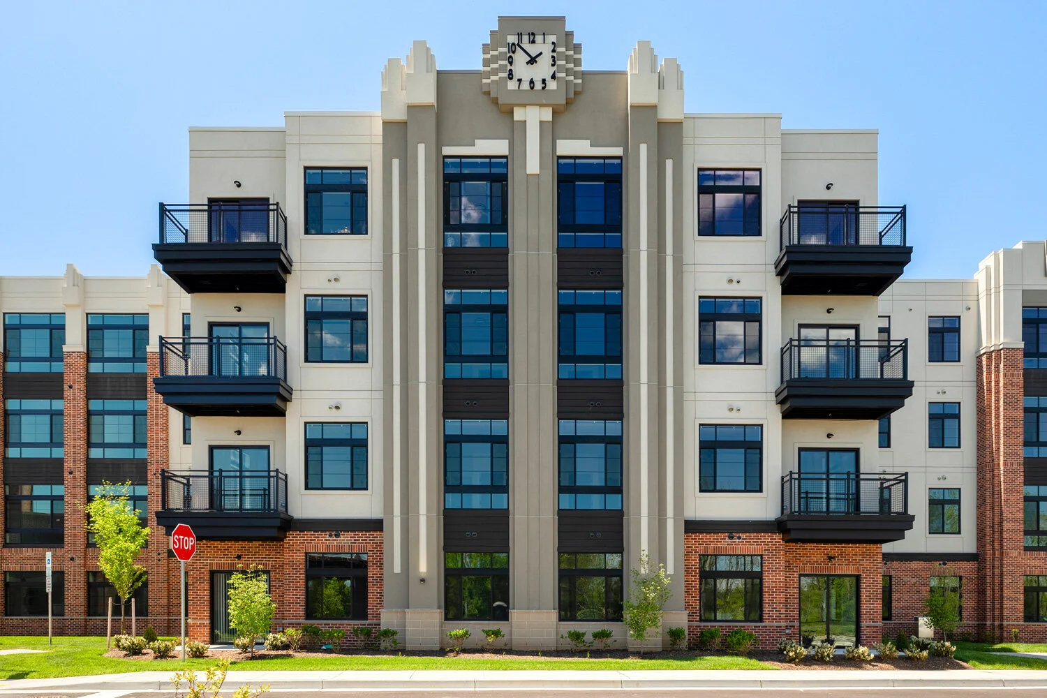 Art deco style apartment building with a prominent clock tower and balconies..jpg