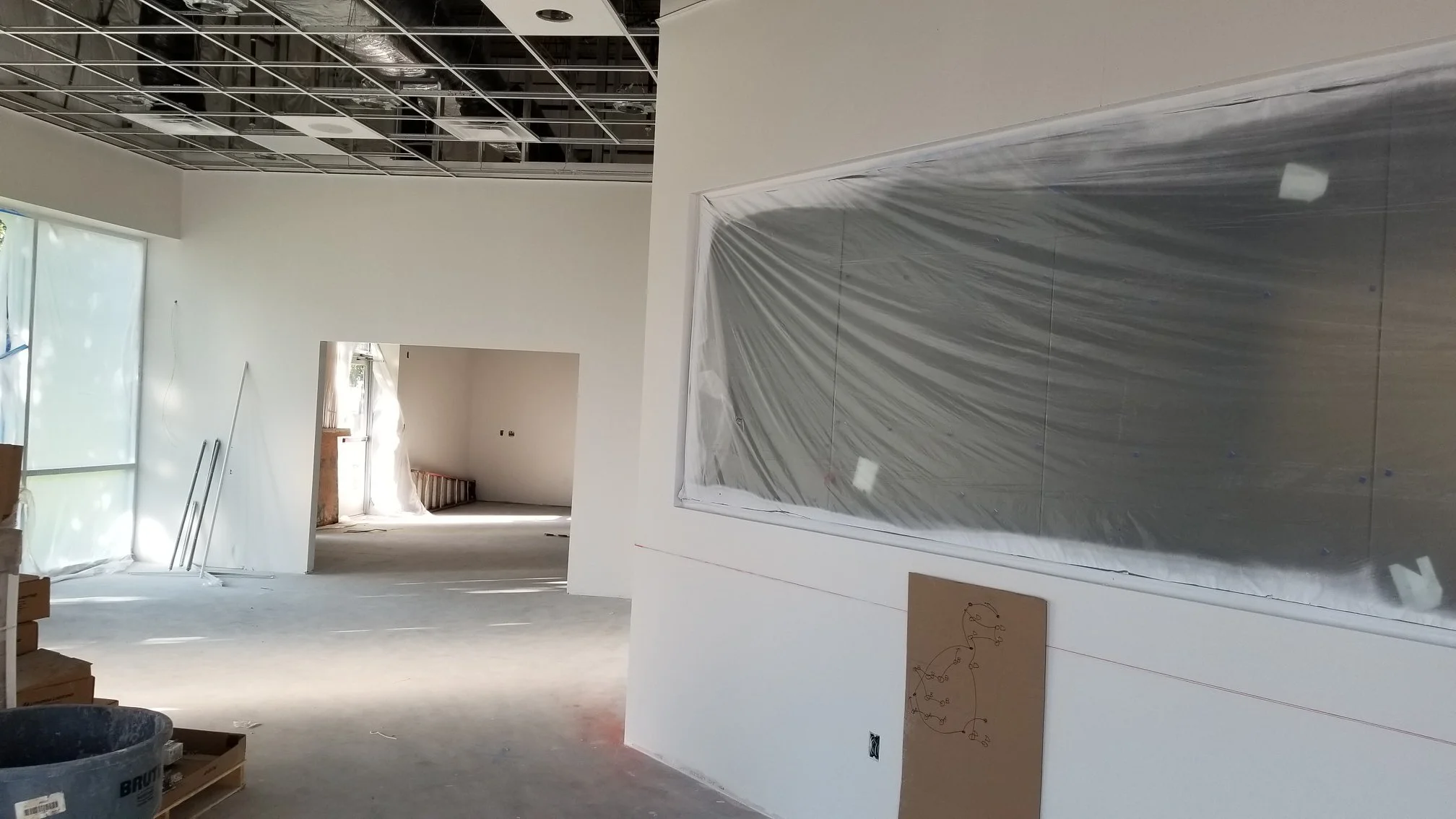 A large white wall featuring a prominent picture, showcasing its size and visual impact..jpg