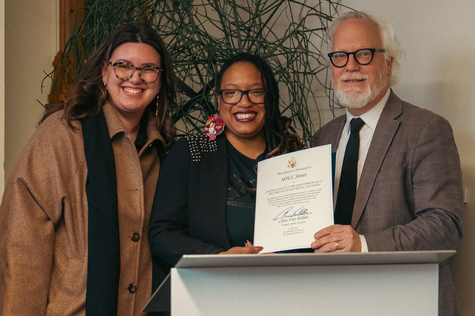  Representative from Senator Chris Van Hollen awarding certificate of accomplishment for incubator.  