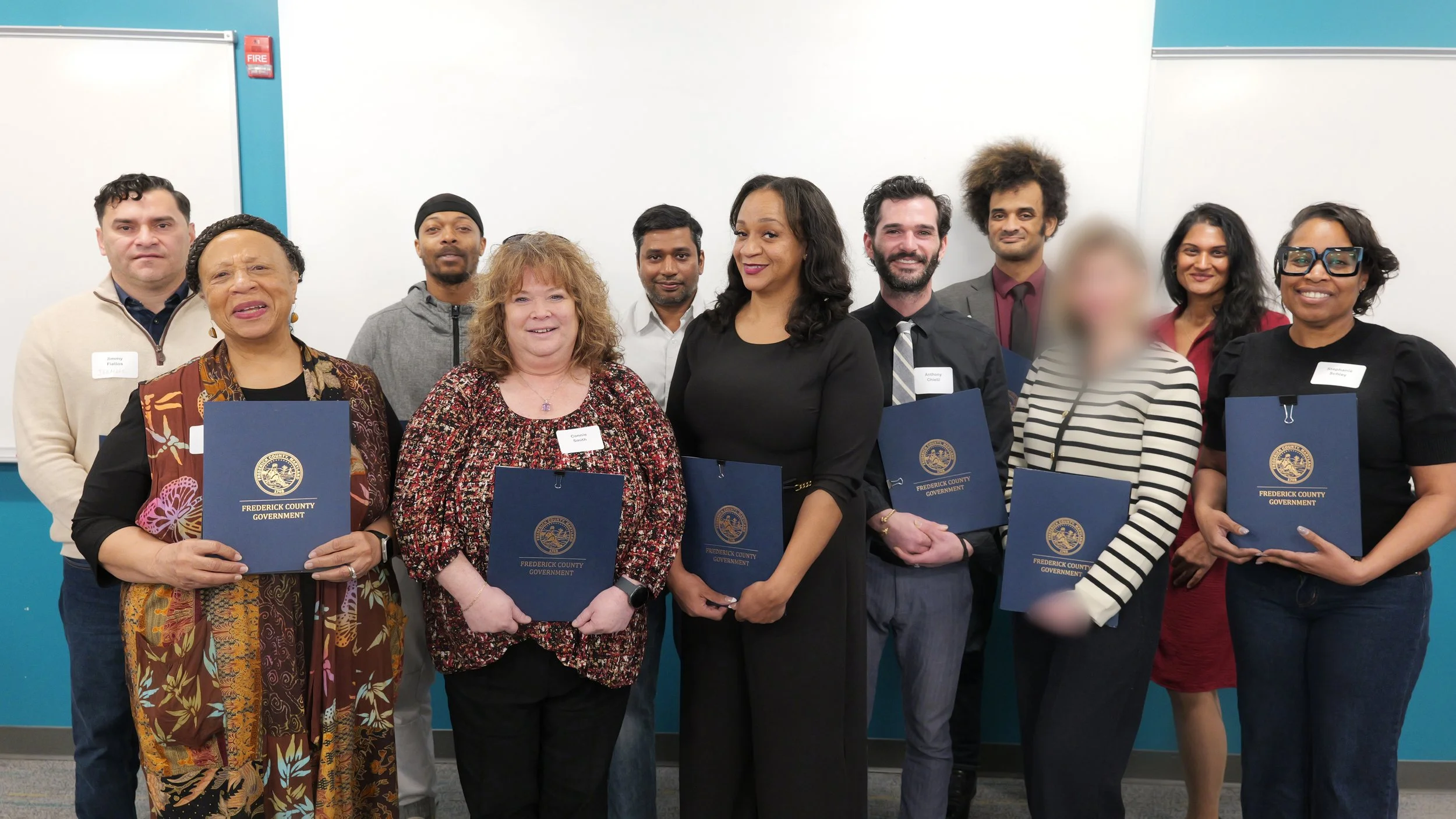 group of graduates holding certificates