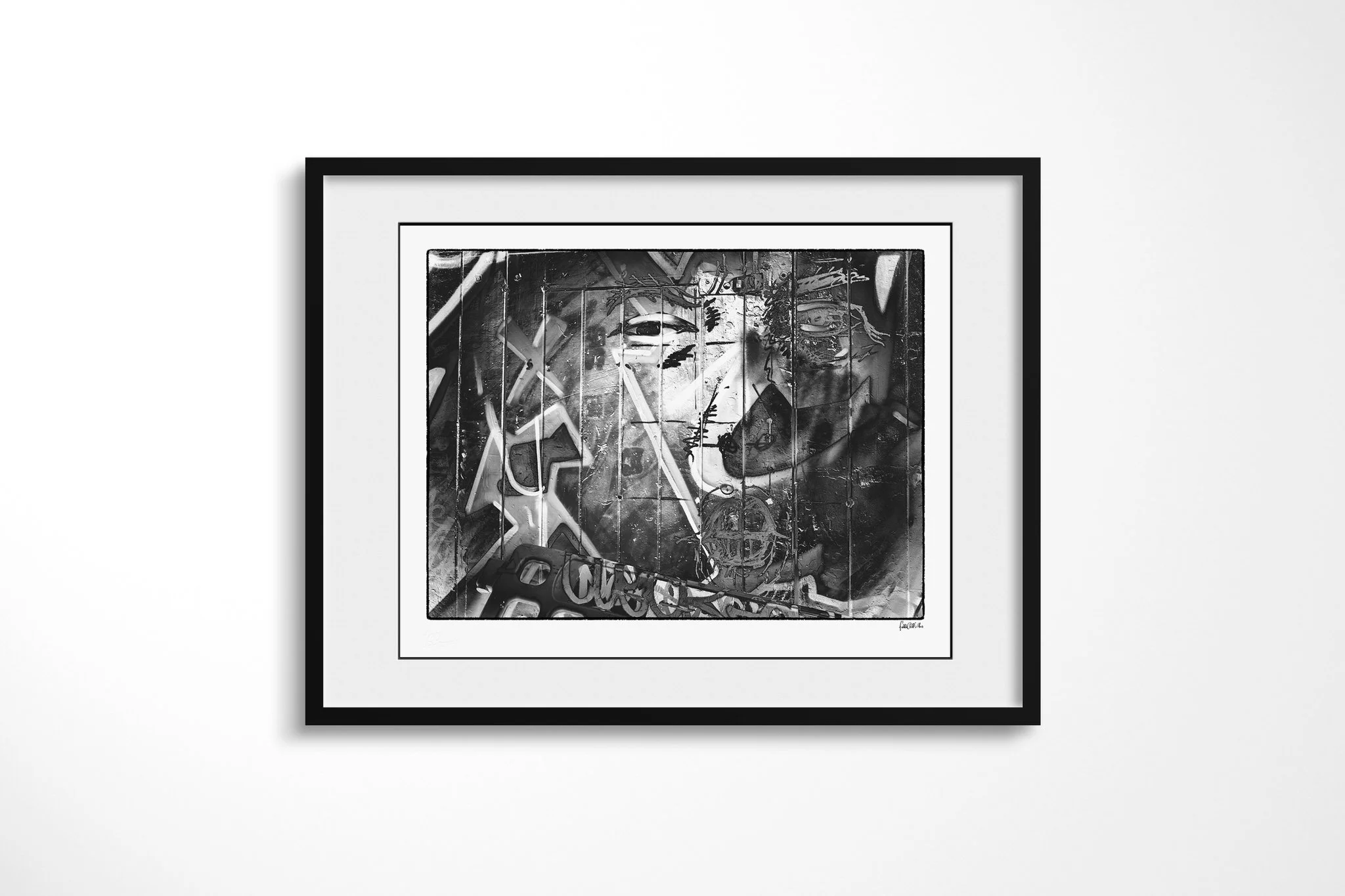 Impression II presented in a black frame and wide white mount, showing a stylised eye and face spanning a panelled monochrome surface with angular graffiti-like lines and symbols.