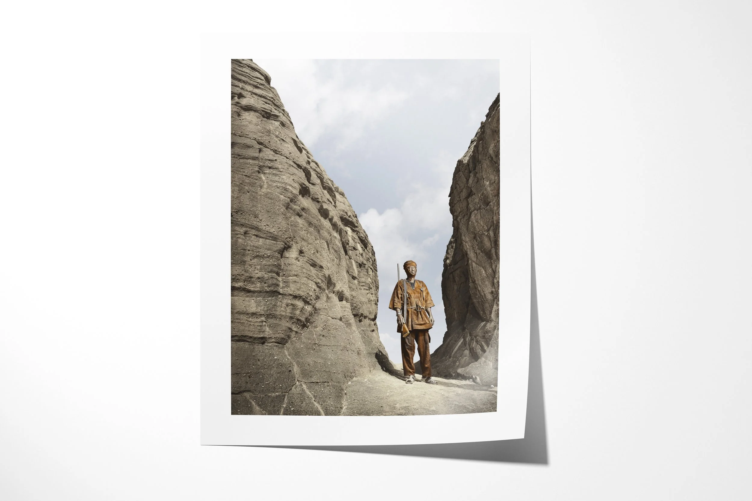 Fine art paper print of Jean, showing Jean standing between towering sandstone walls in a narrow mountain passage.