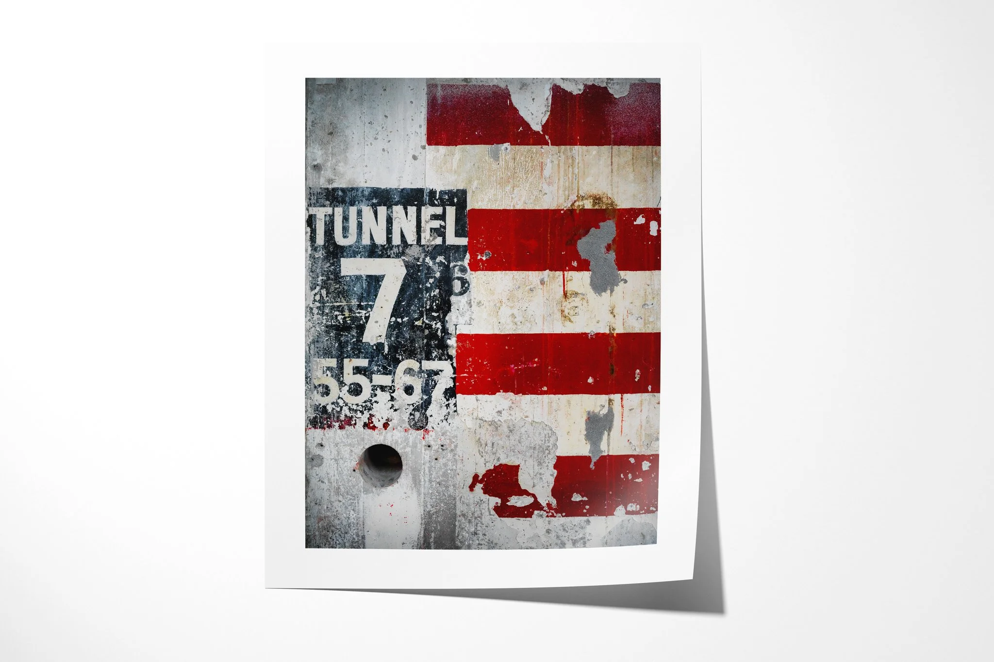 Unframed fine art paper print of Weathered, showing a distressed Tunnel 7 sign beside peeling red-and-white stripes and a circular recess on a weathered industrial wall.