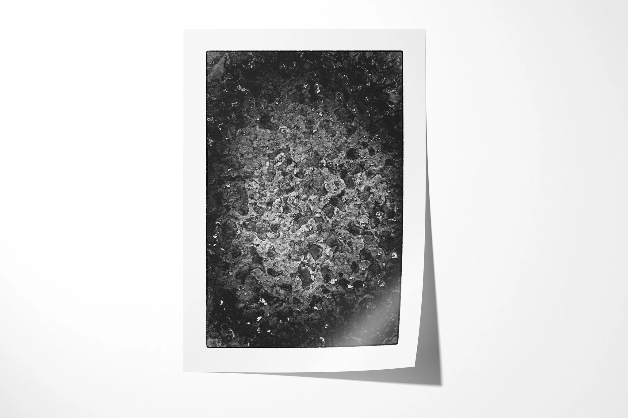 Fine art paper print of Patina, showing a mottled monochrome surface with irregular pale encrusted patches, pits and dark weathered texture.