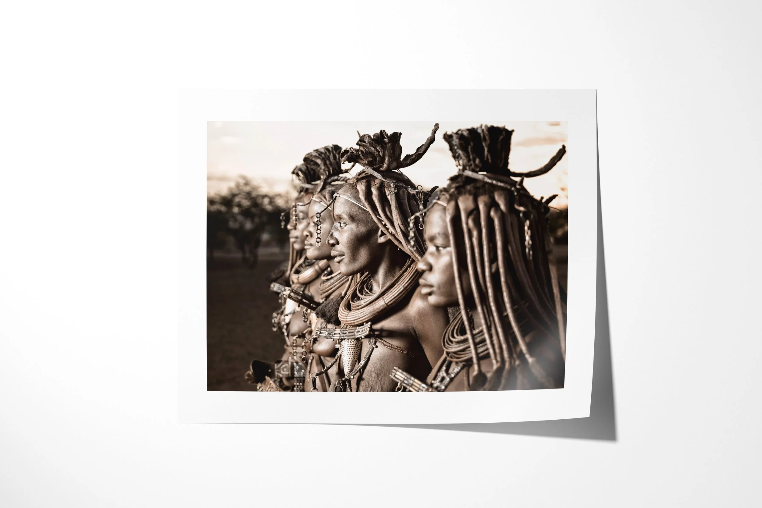 Fine art paper print of Mburaivaka, Waruakawa, Katitjii and Kayeripewa, showing four Himba women shown in close profile, their otjize-dressed hair and jewellery overlapping across the frame.