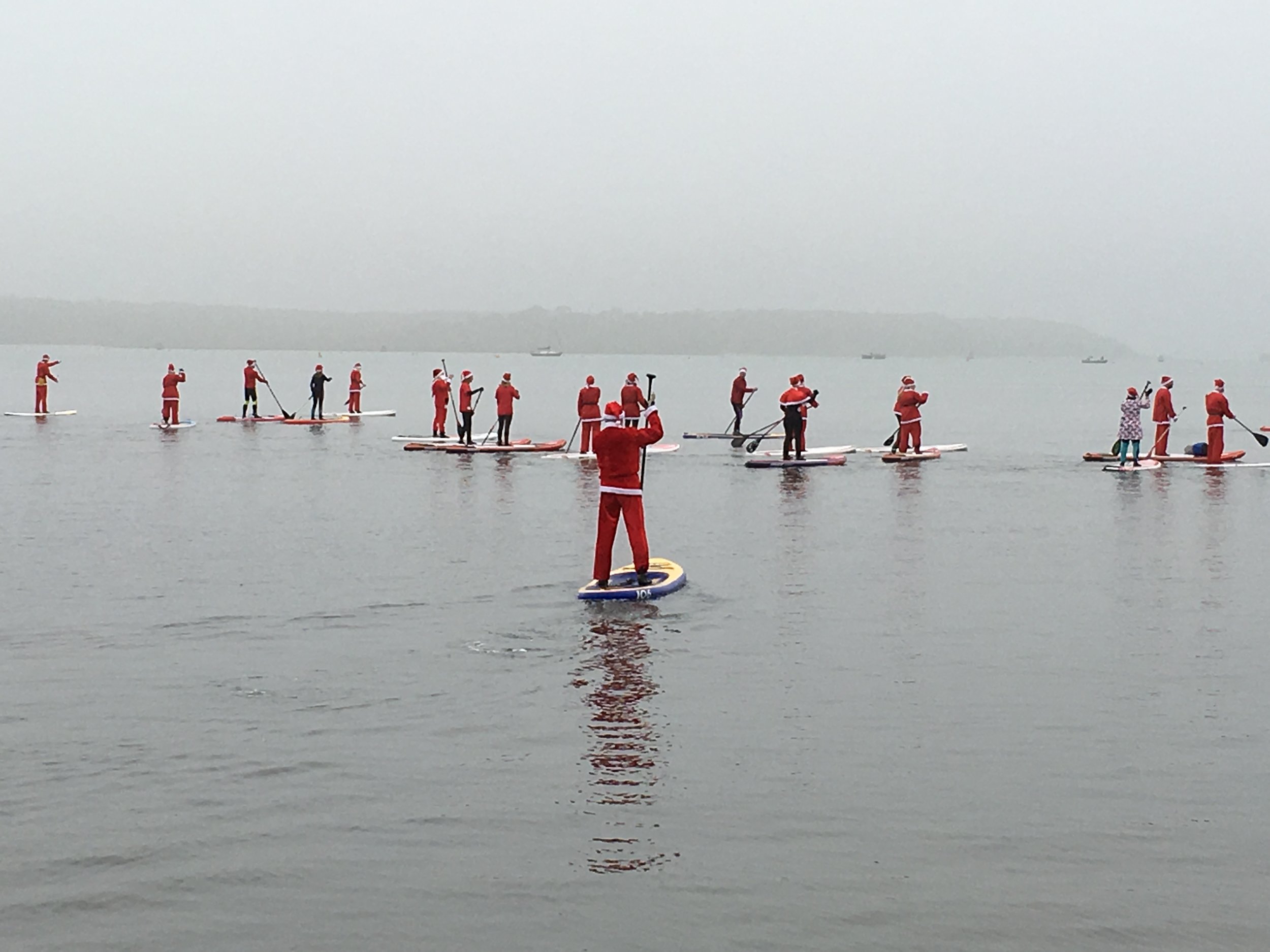 Santa SUP paddle in front of Brownsea