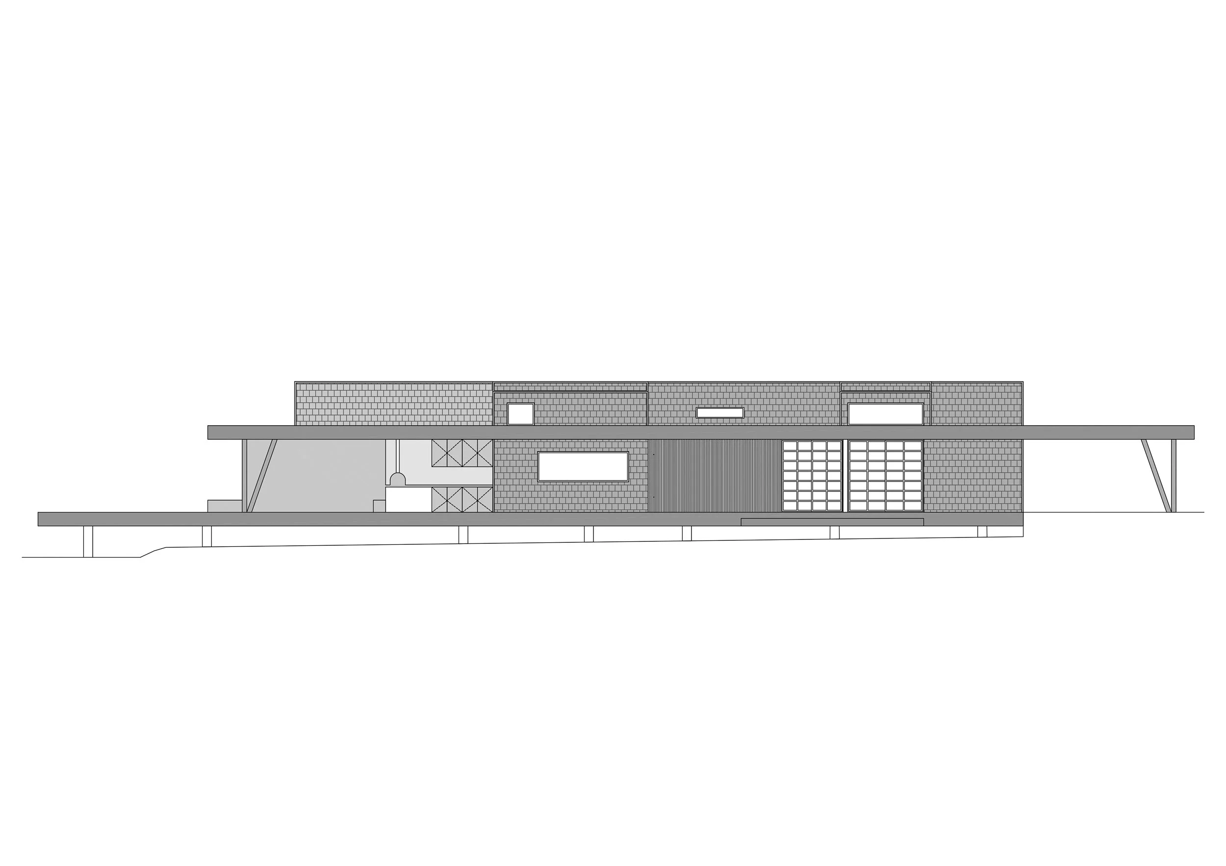 Fachada de Casa CAJÚ donde se ven los techos altos de la casa y una pérgola de concreto.
