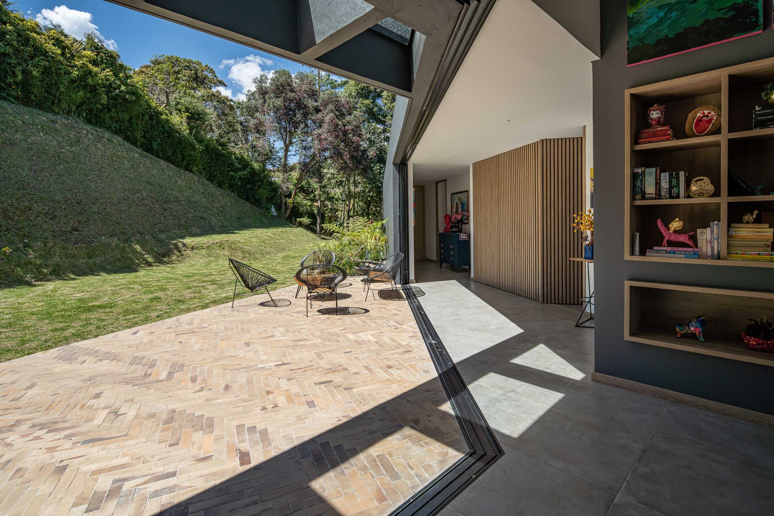 Terraza de Casa JANA vista desde la sala con puertas vidrieras abiertas. El Retiro, Antioquia, Colombia.