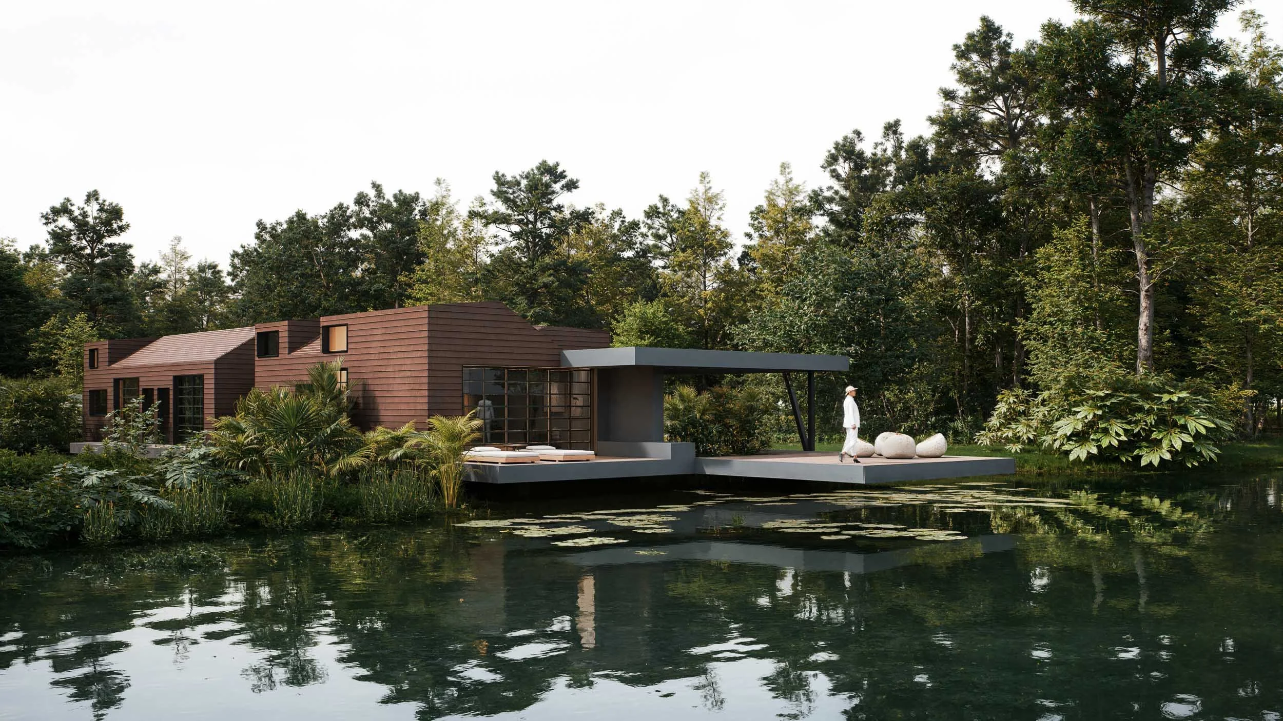 Casa CAJÚ, diseñada por TOLEDO Estudio de Arquitectura con una terraza flotando sobre un lago. En el fondo aparece el bosque del lote en el Alto de Las Palmas en Medellín, Colombia.