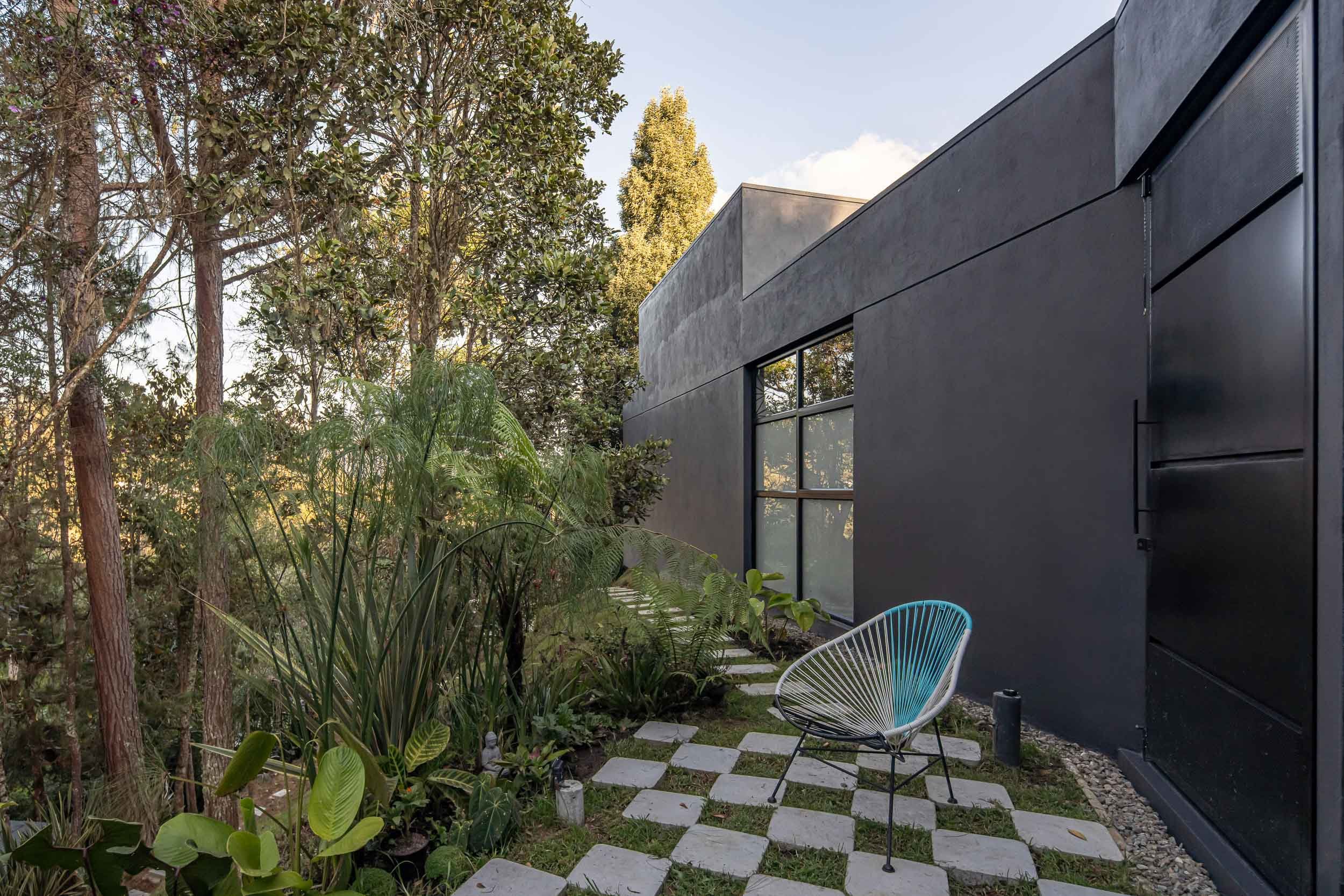 Ambiente exterior de Casa JANA, una vivienda moderna diseñada al lado de un bosque en El Retiro, Colombia.