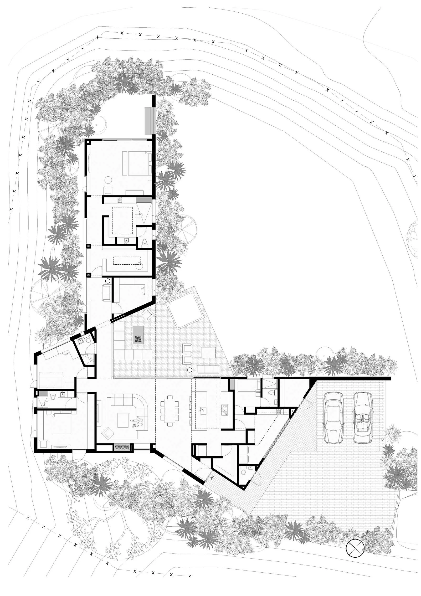 Planta arquitectónica que muestra la distribución de una casa moderna en forma de L. Donde la zona privada está hacia un lado y la zona social se encuentra en el lado opuesto. Diseño arquitectónico por TOLEDO ESTUDIO DE ARQUITECTURA.