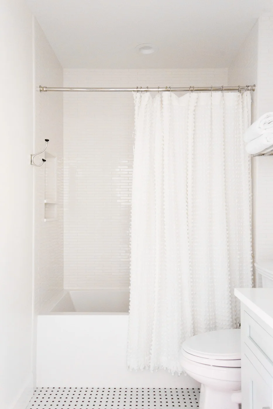 Black_white+tile+and+pom+pom+shower+curtain+--+Studio+McGee.jpg