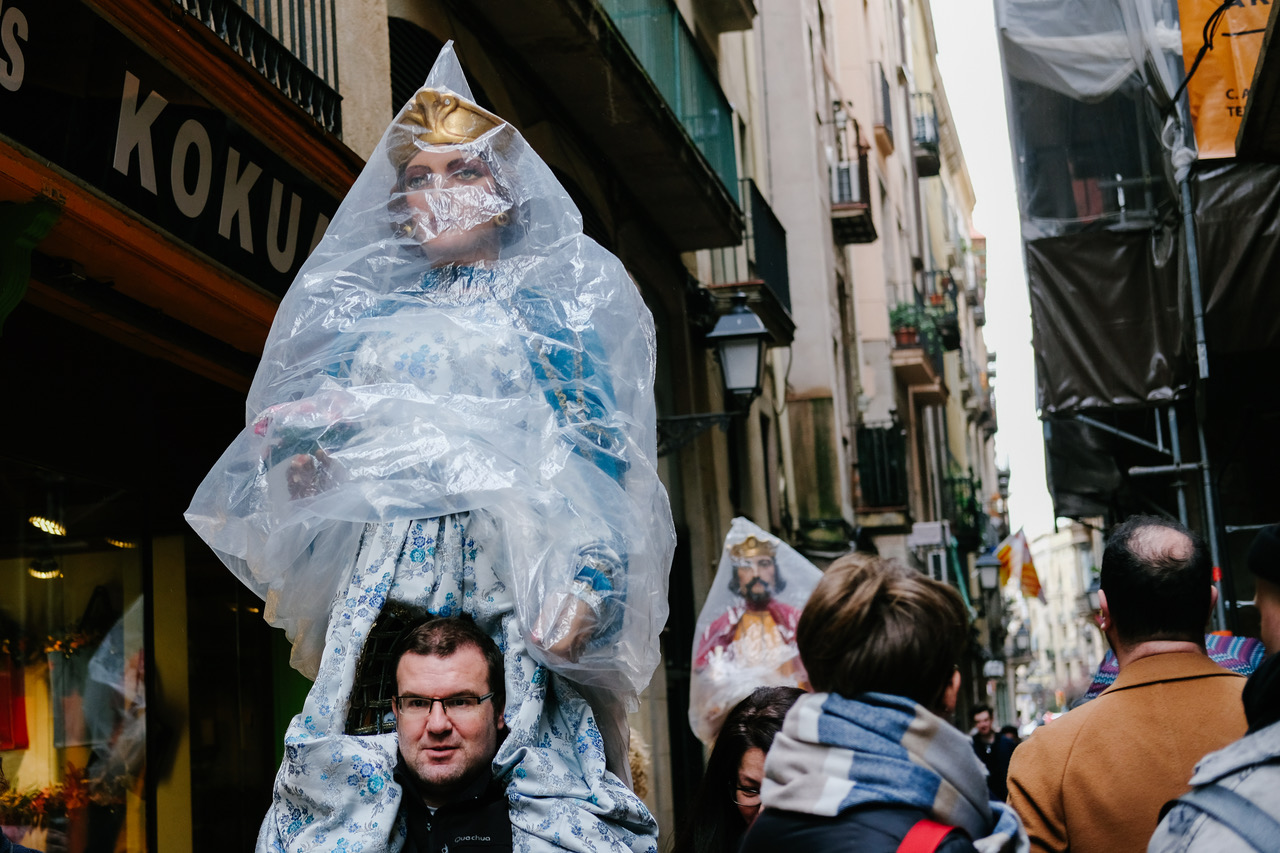  A man in Barcelona carries one of the gigantes y cabezudos, or, giants and big-heads, used during the Festes de Sant Josep Orio, March 27, 2018.  