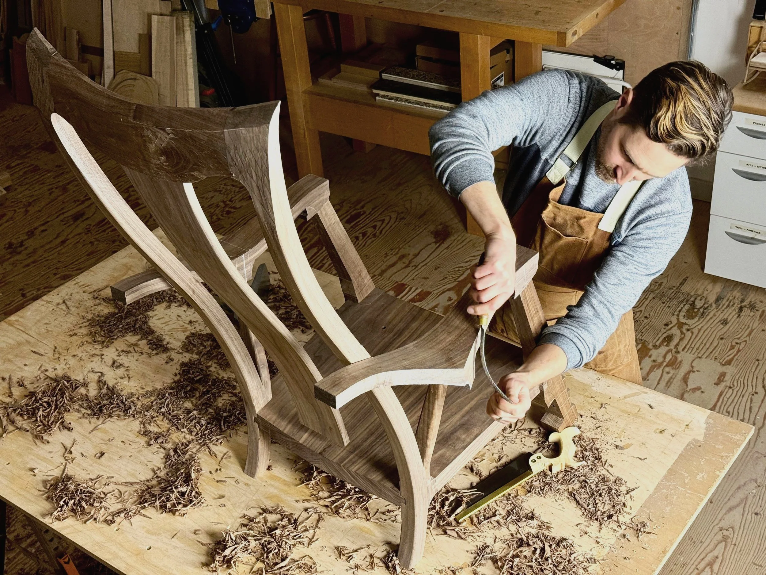 Hand shaping a walnut rocking chair