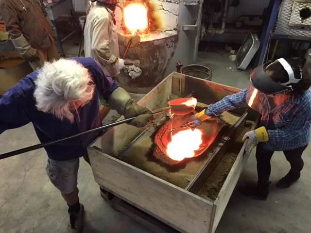Pouring the glass (large snips are used to clip off drips of glass as to not make a mess.)