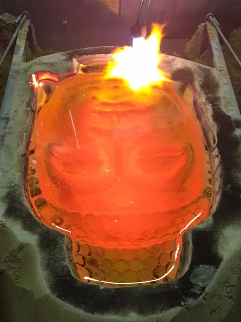 Close-up view of the Buddha head being torched. 