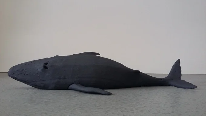 A painted bronze sculpture of a stranded whale. Edition of 5, signed and numbered. Size: 40 cm (16 inches) long