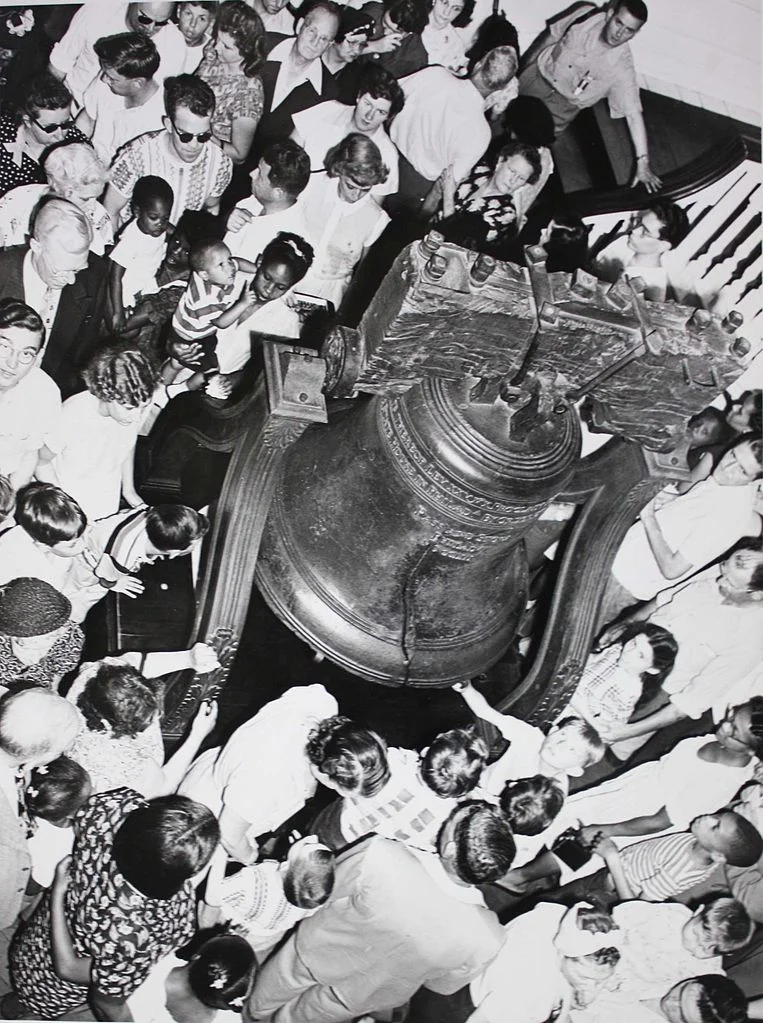 A crowd gathers around the Liberty Bell in Independence Hall, July 3, 1951. Photo: Abbie Rowe, photographer for the National Park Service Independence National Historic Park Library and Archive, Philadelphia PA. Digitization by Wehwalt