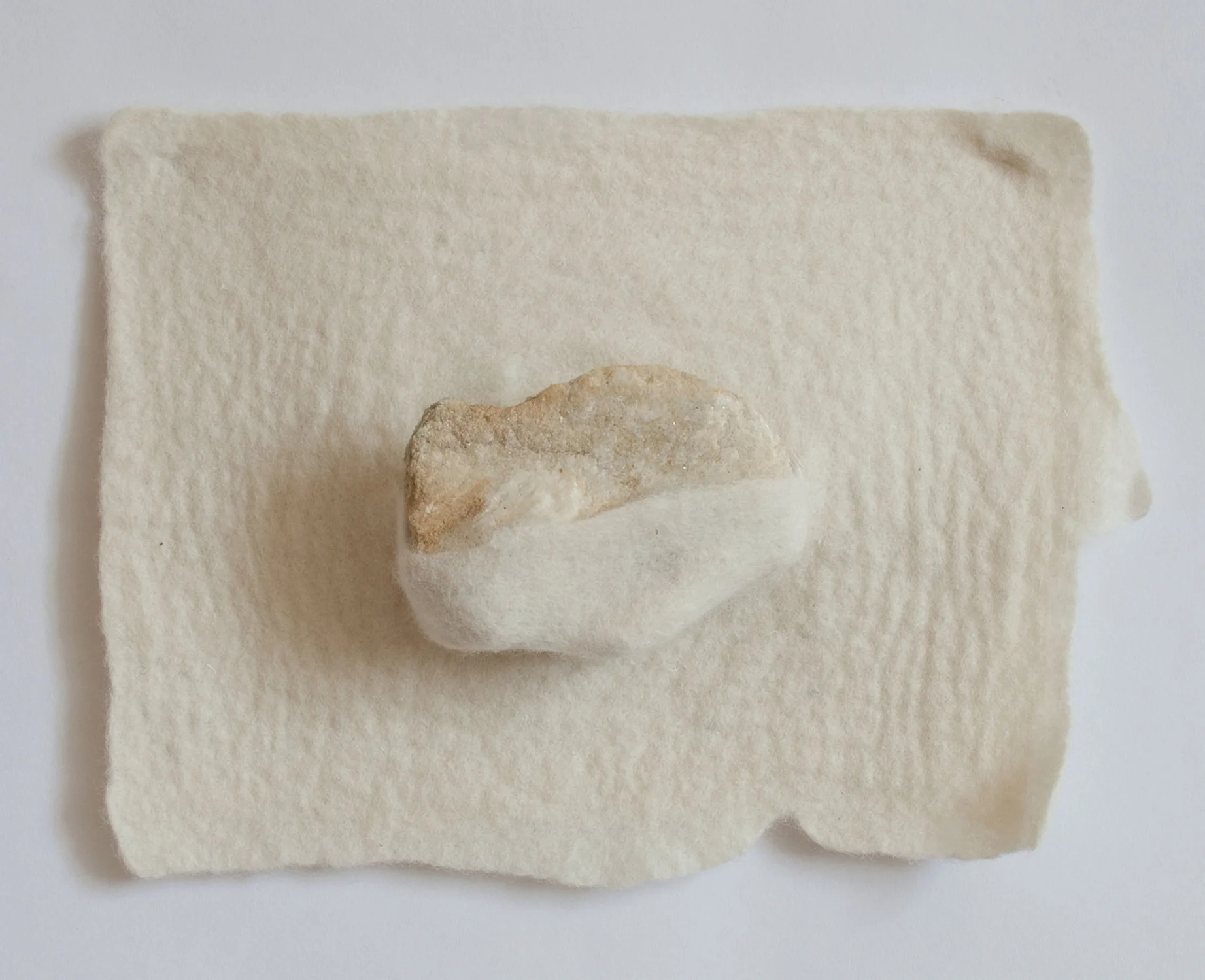 Between a rock and a soft place / the landscape holds Handfelted merino wool, rock 2017