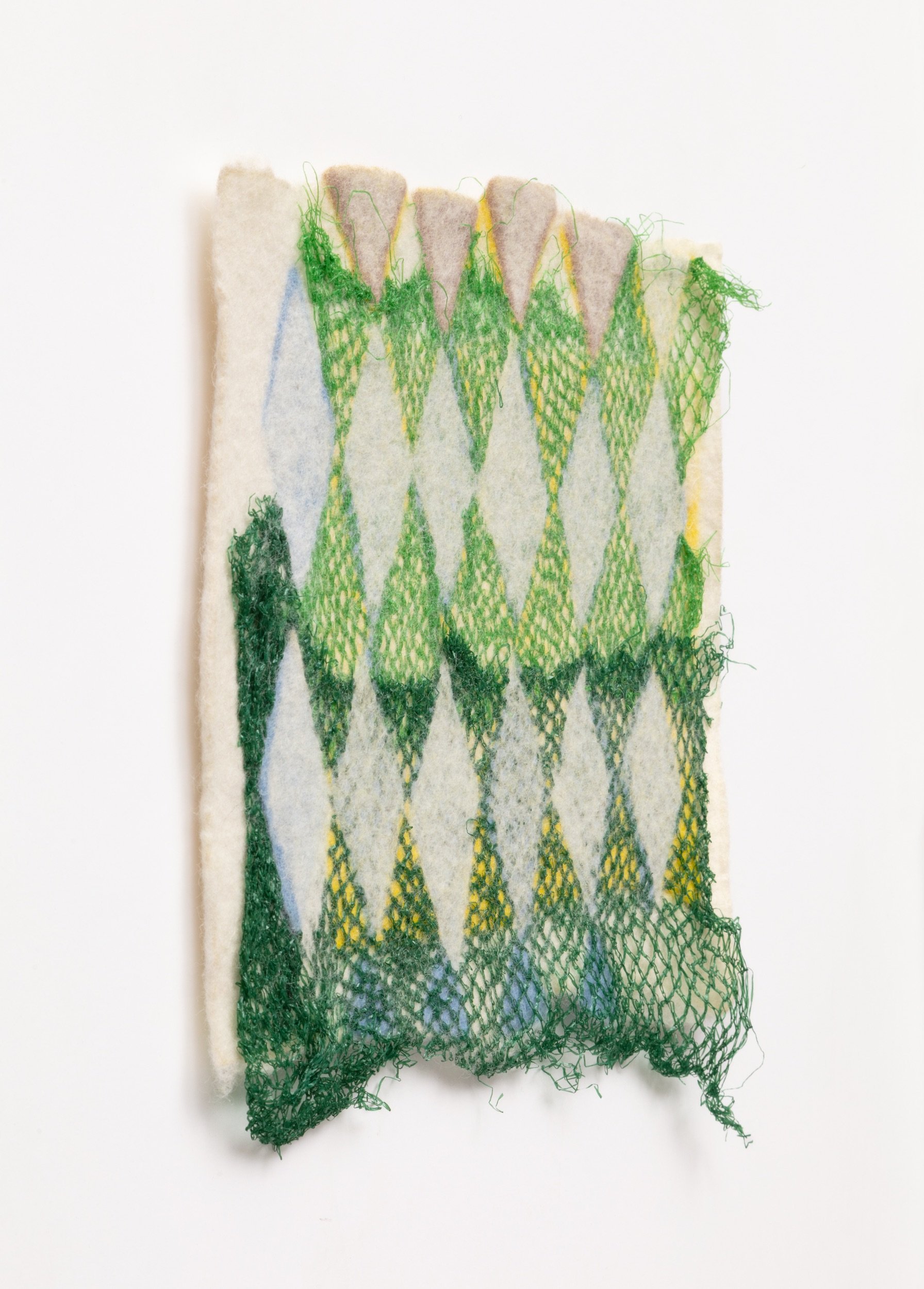  Untitled, 2022  Handfelted merino wool, plastic produce nets 