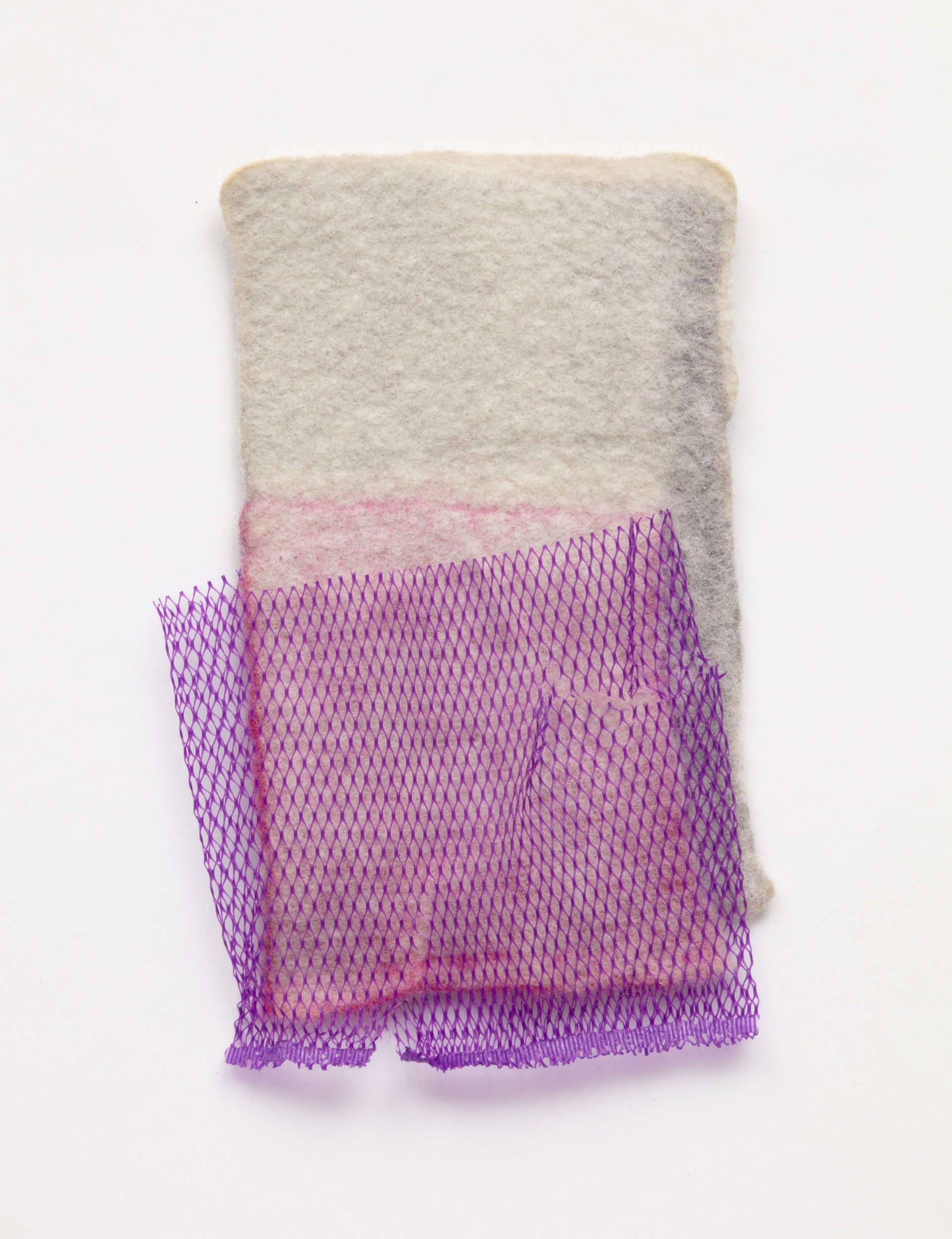  Untitled, 2021 (front)  Handfelted merino wool, plastic produce net 