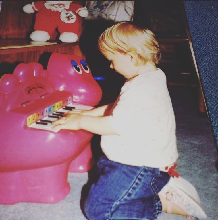 One and half year old me making up songs on my Barney piano. 