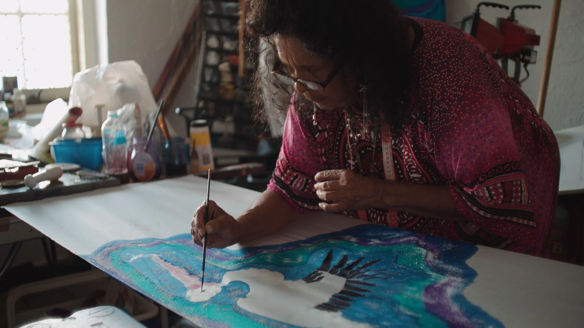 Betty Sumner painting on silk in Raukkan. Photo Change Media, March 2017