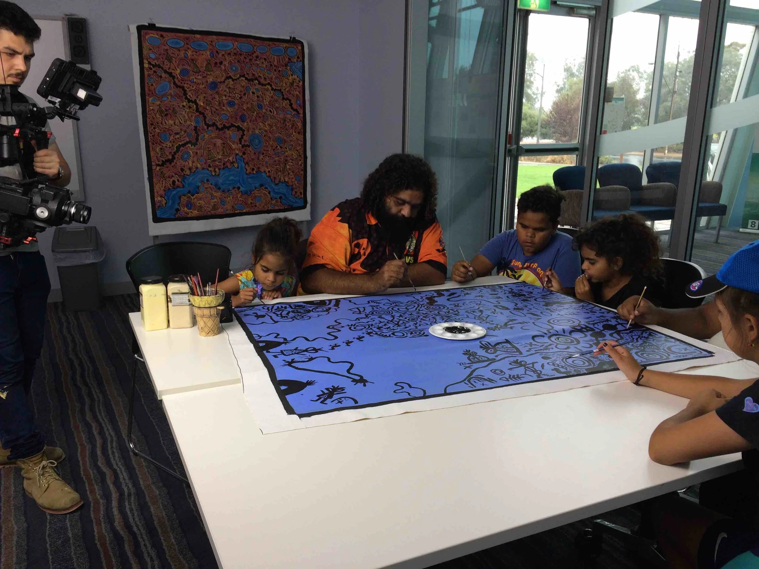 Cedric and his family painting at the Pt Pirie Arts Centre. Photo Carl Kuddell, April 2017