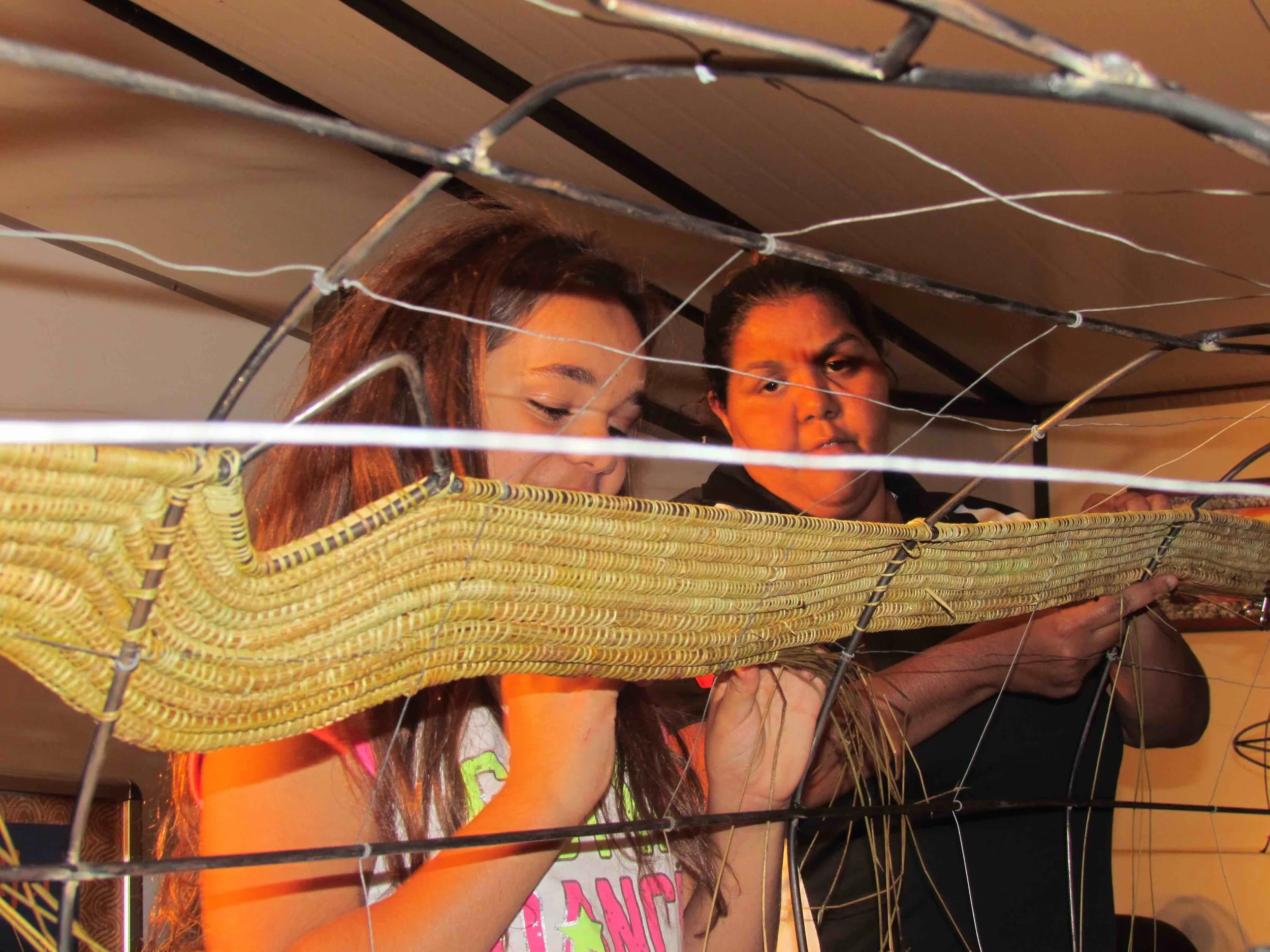 Bessie Rigney (right) and Cheyenne Carter weaving Kondoli, 2015. Photo courtesy of the artist