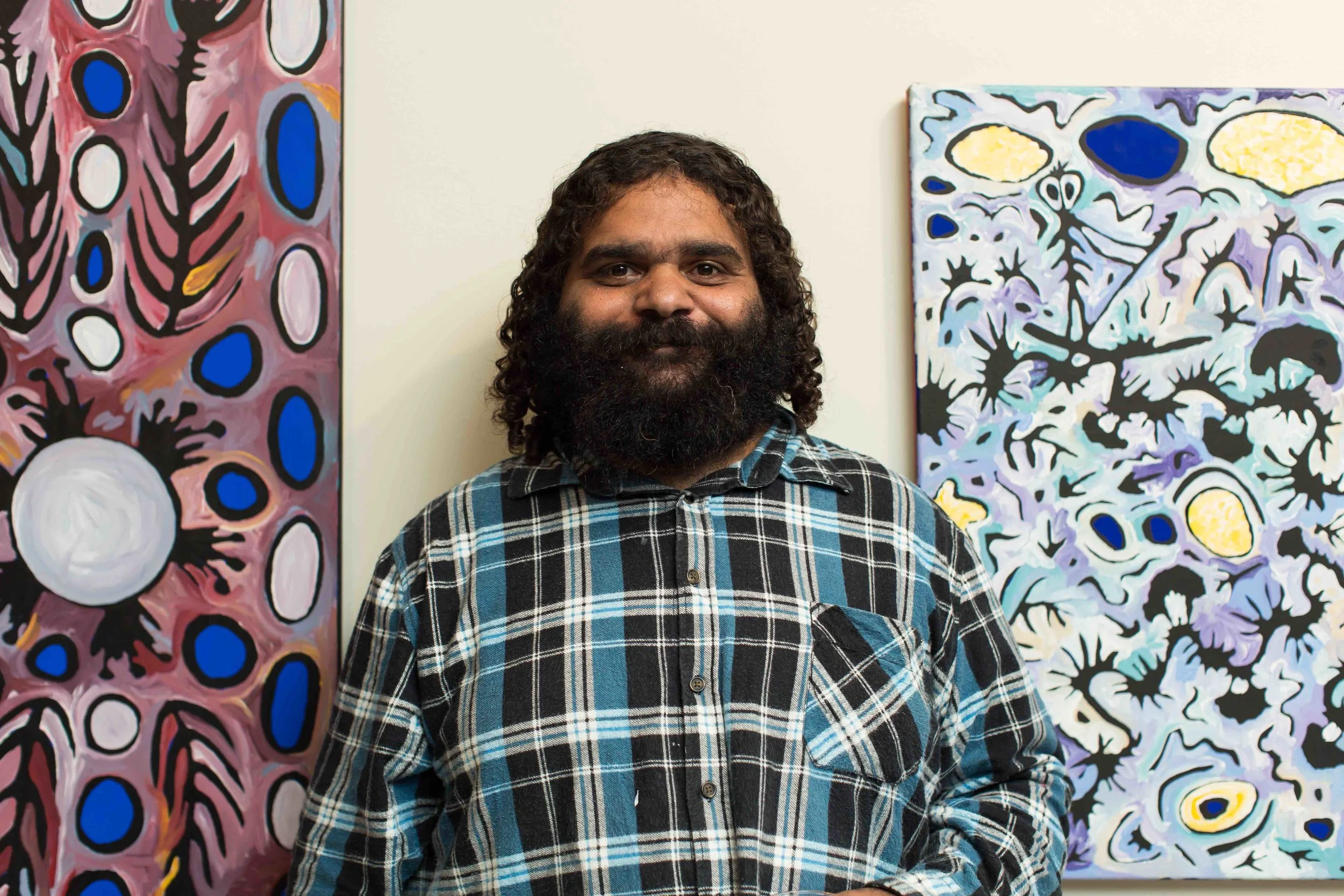 Cedric Varcoe in front of his work. Photo Johanis Lyons-Reid / Change Media