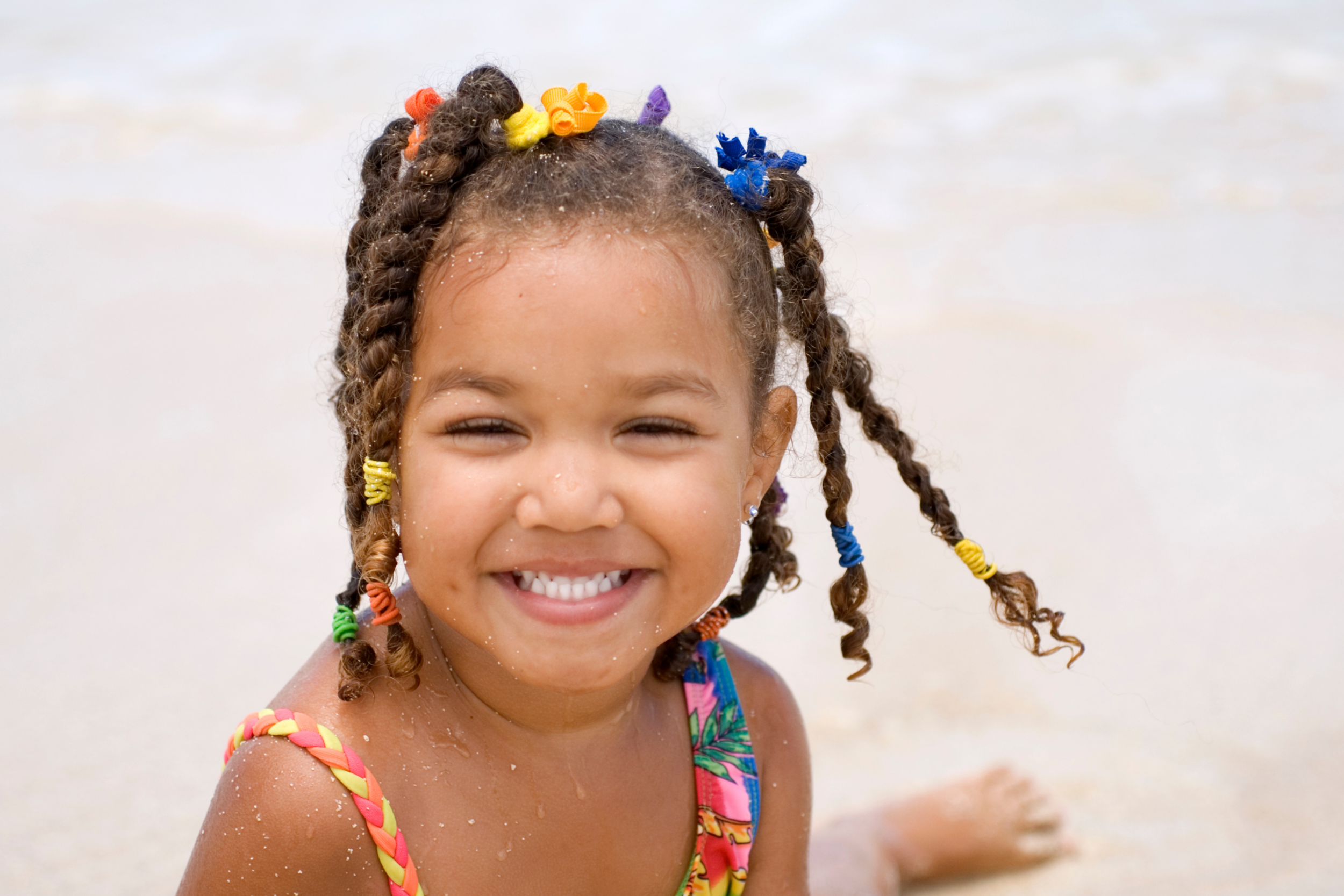 Smiling girl with braids on the beach