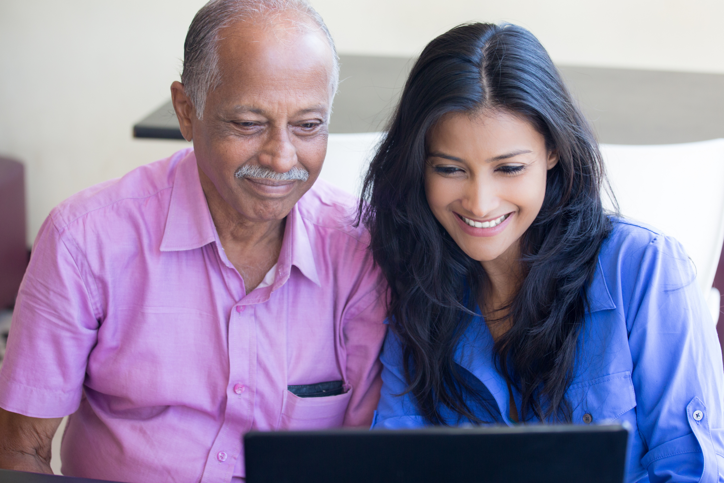 Man uses laptop with daughter